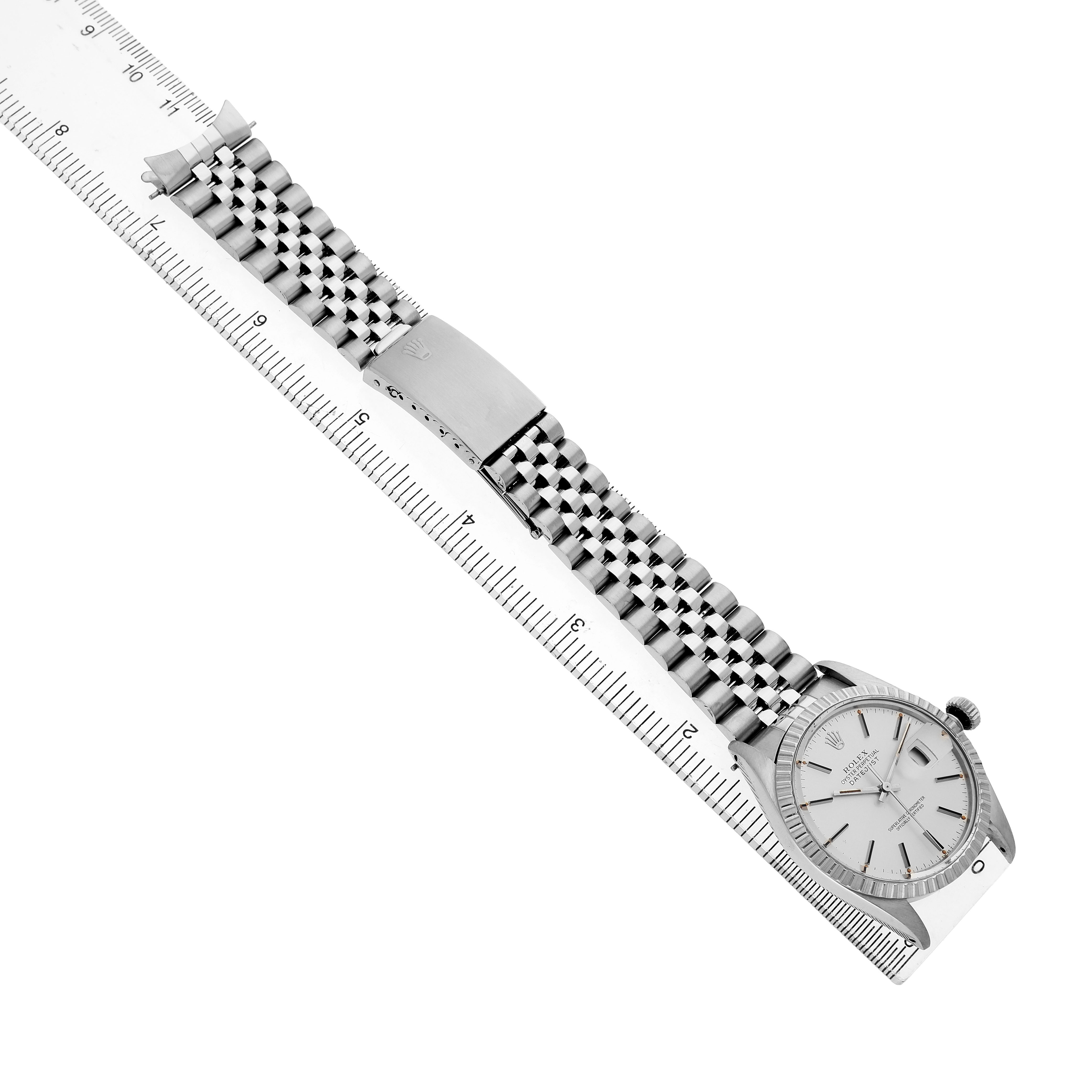 The image shows a Rolex Datejust 16030 Men's Stainless Steel Silver Dial watch laid flat, displaying the bracelet and clasp with a partial view of the dial at an angle.