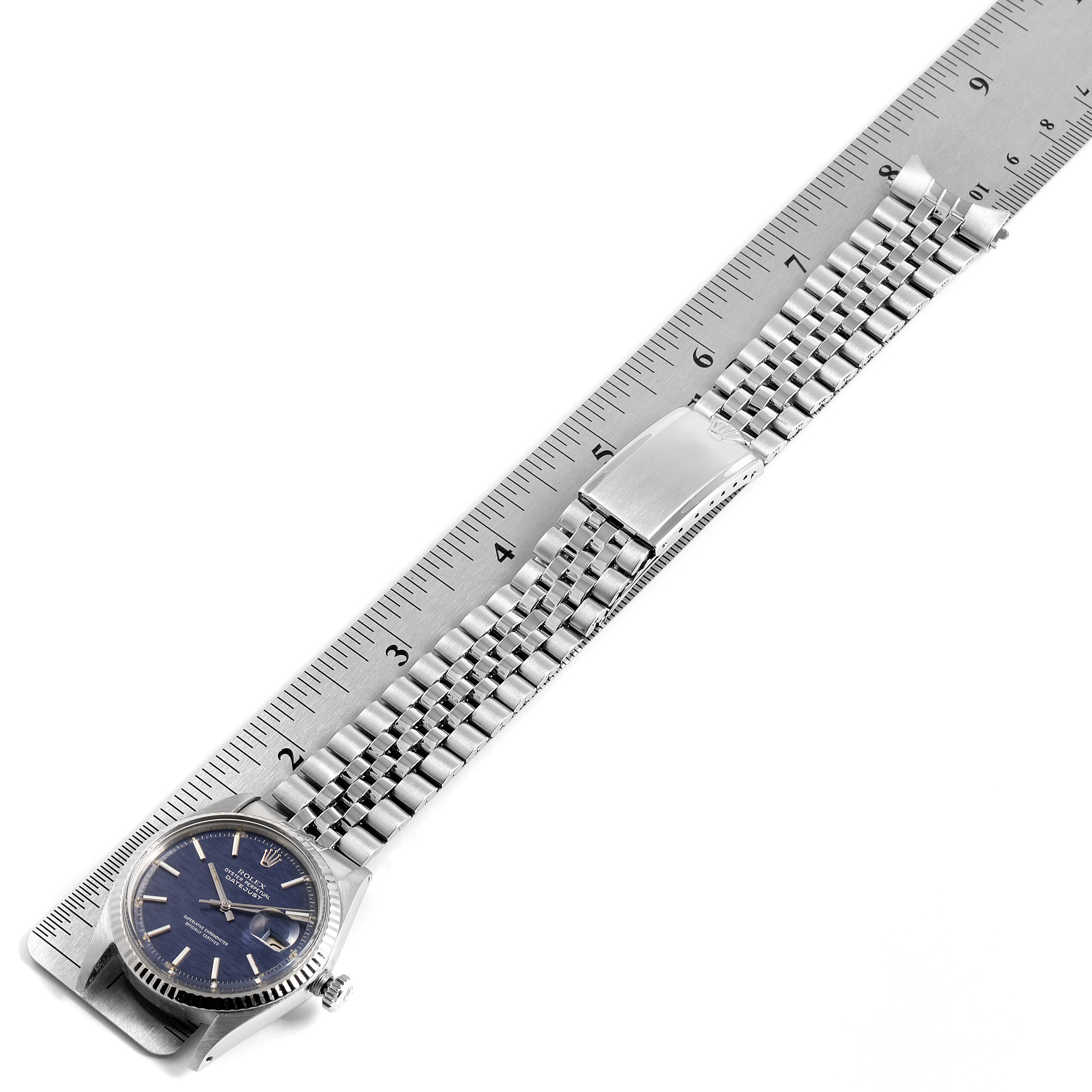 This image shows a Rolex Datejust 1601 Men
s Stainless Steel Blue Dial 1601 Men
s Stainless Steel Blue Dial watch laid flat, with its clasp open and a ruler measuring its length.
