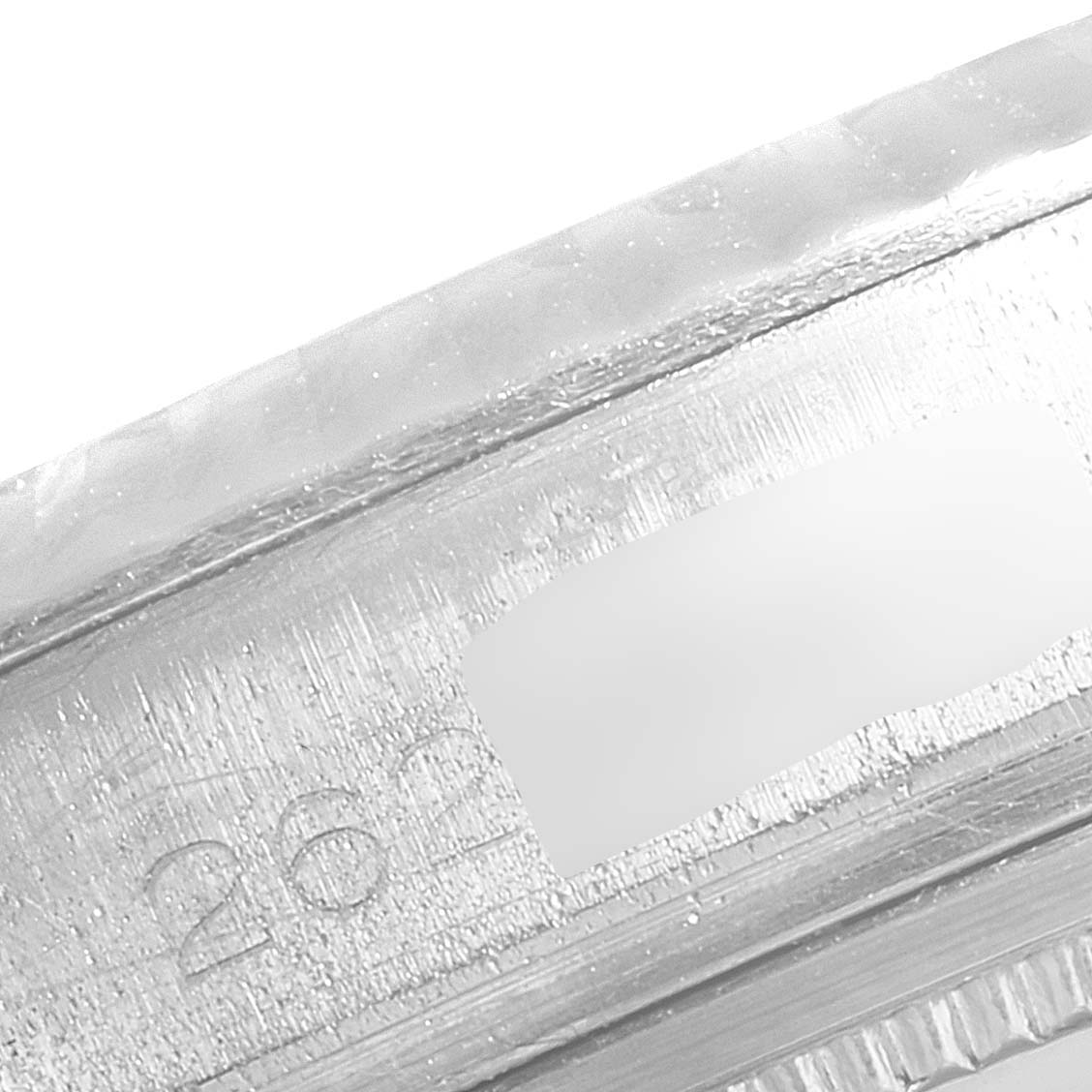 The image shows an extreme close-up of the case band and serial number of a Rolex Datejust 1601 Men
s Stainless Steel Blue Dial 1601 Men
s Stainless Steel Blue Dial watch.