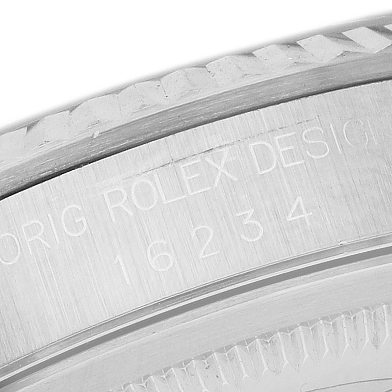 The image shows an angled close-up of the Rolex Datejust 16234 Men's Stainless Steel Silver Dial's bezel and case with engraved model number.