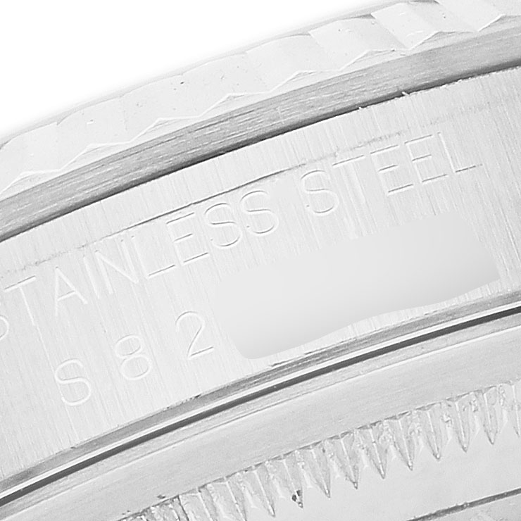 The image shows a close-up of the engraved text on the stainless steel side of the Rolex Datejust 16234 Men's Stainless Steel Silver Dial watch casing.