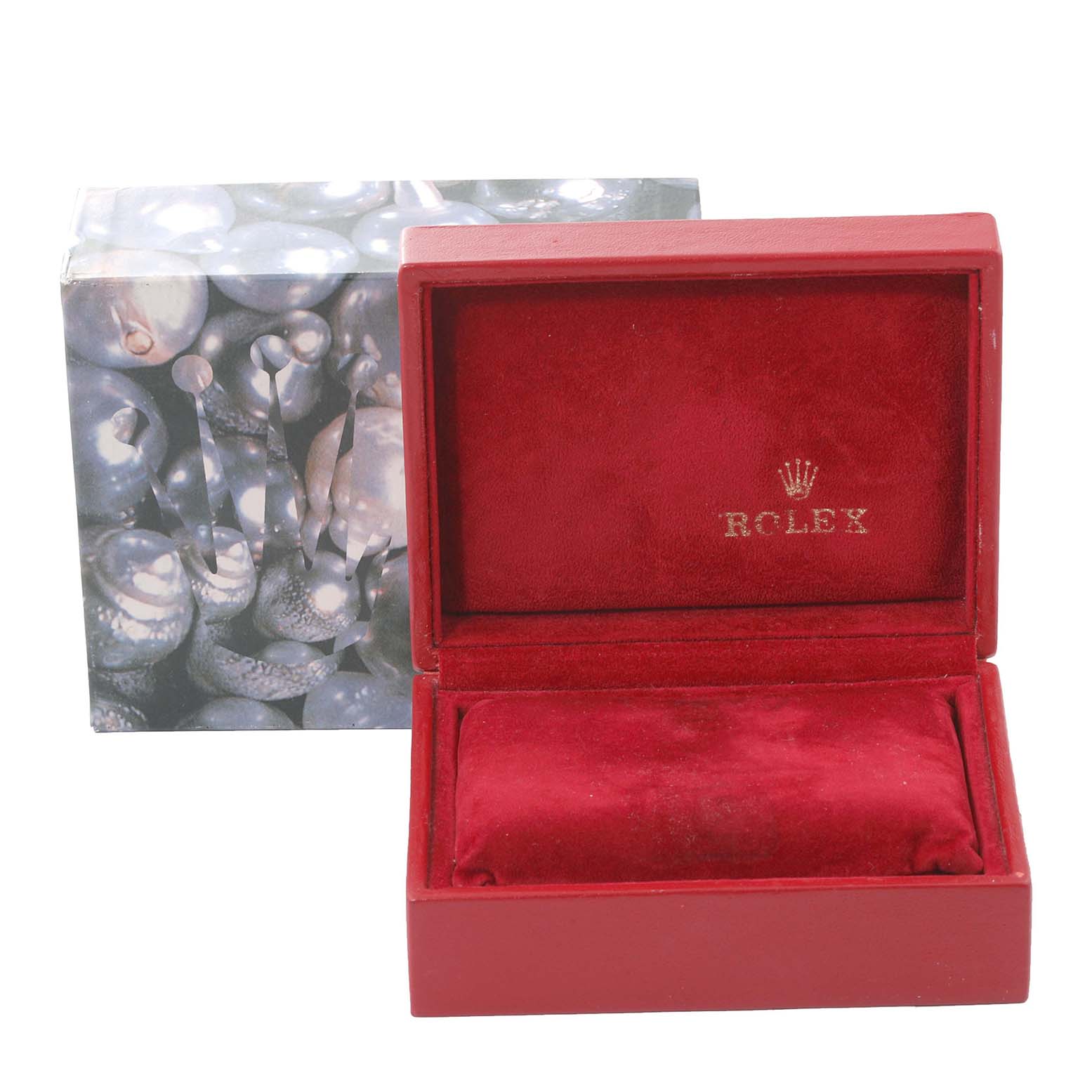 The image shows a red Rolex watch box for a Datejust model, open to reveal its interior.