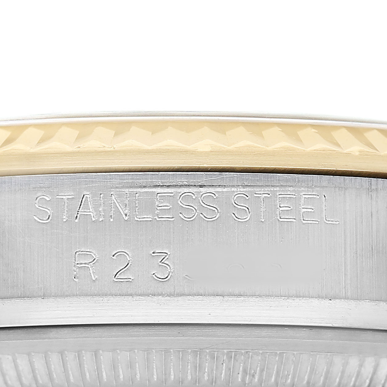 The image shows a close-up of the side and bezel of a Rolex Datejust 16013 Men's Steel and Gold (two tone) Champagne Dial, highlighting the "STAINLESS STEEL" engraving.