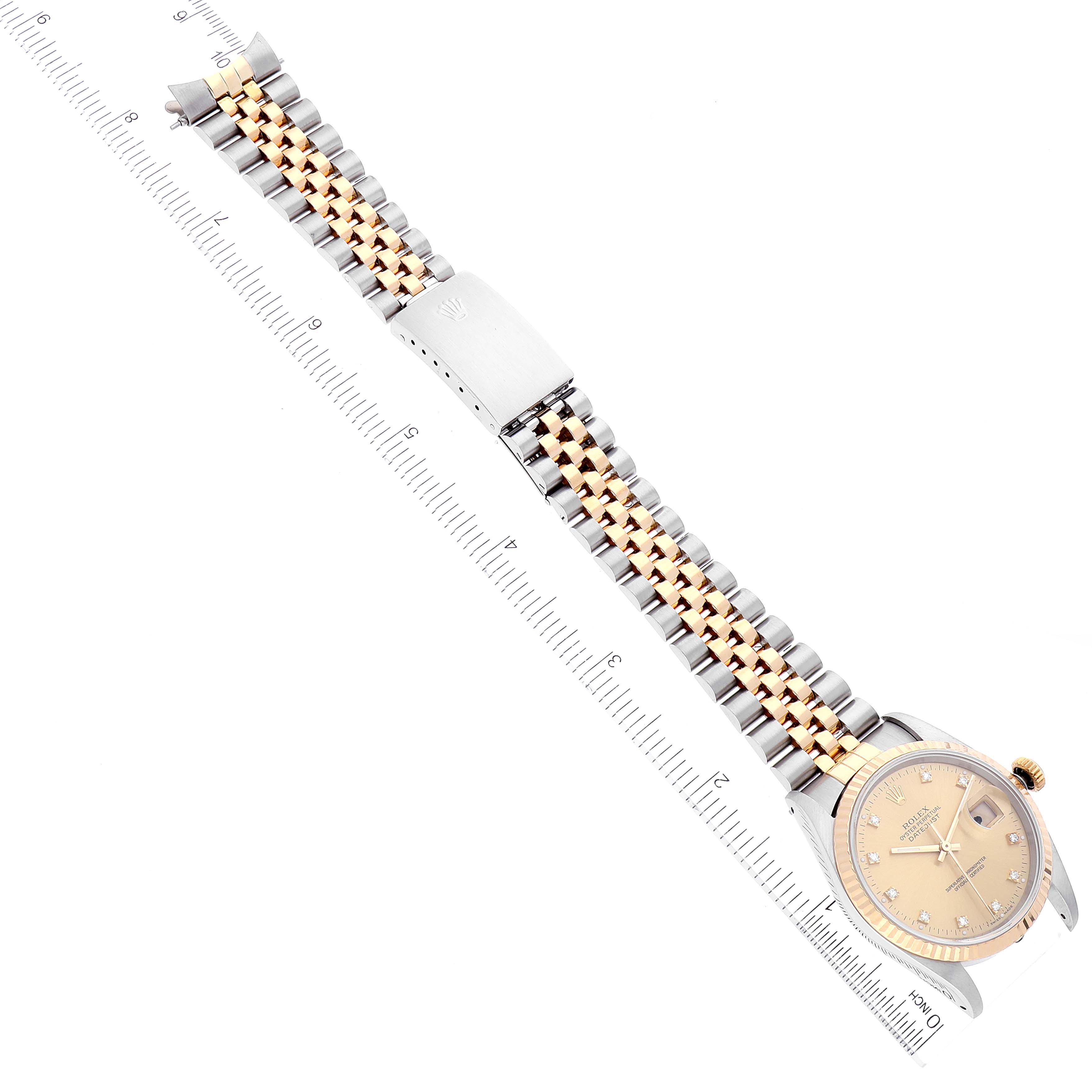 The image shows a Rolex Datejust 16233 Men's Steel and Gold (two tone) Champagne Dial 16233 Men's Steel and Gold (two tone) Champagne Dial watch laid flat, displaying the face, bezel, crown, bracelet, clasp, and an attached ruler for measurements.