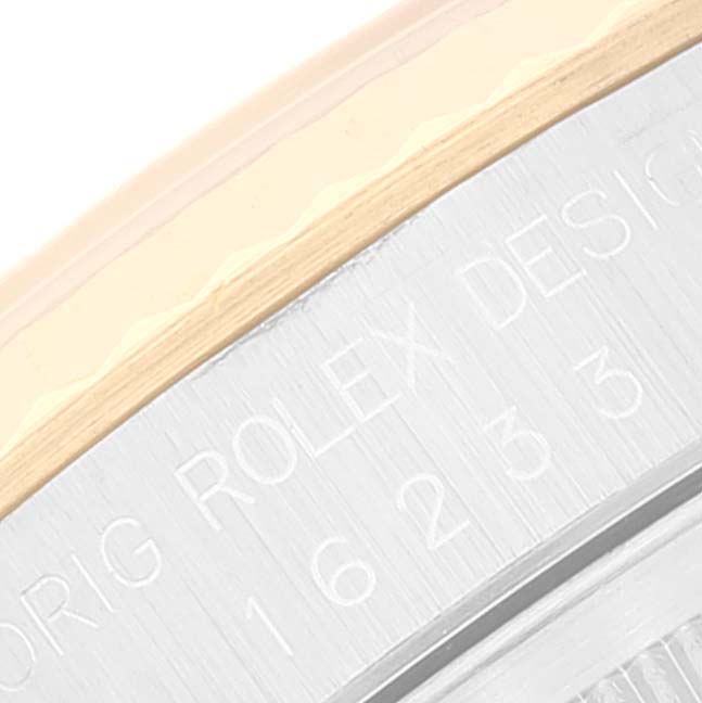 The close-up image shows the edge of the bezel and part of the brushed metal case back of a Rolex Datejust 16233 Men's Steel and Gold (two tone) Champagne Dial 16233 Men's Steel and Gold (two tone) Champagne Dial watch.