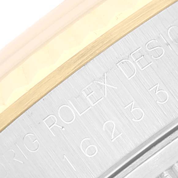 The image shows an engraved side view of a Rolex Datejust 16233 Men's Steel and Gold (two tone) Champagne Dial 16233 Men's Steel and Gold (two tone) Champagne Dial model, focusing on the serial number and part of the bezel.