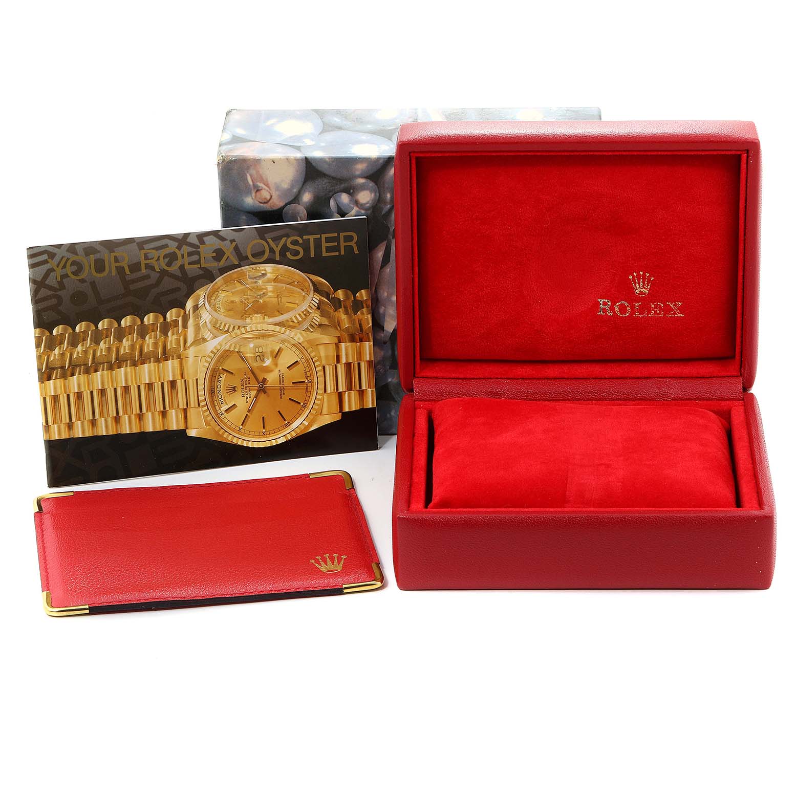 This image shows a Rolex Datejust 79173 Women's Steel and Gold (two tone) White Dial 79173 Women's Steel and Gold (two tone) White Dial watch box, a brochure, and a red cardholder at a frontal angle.