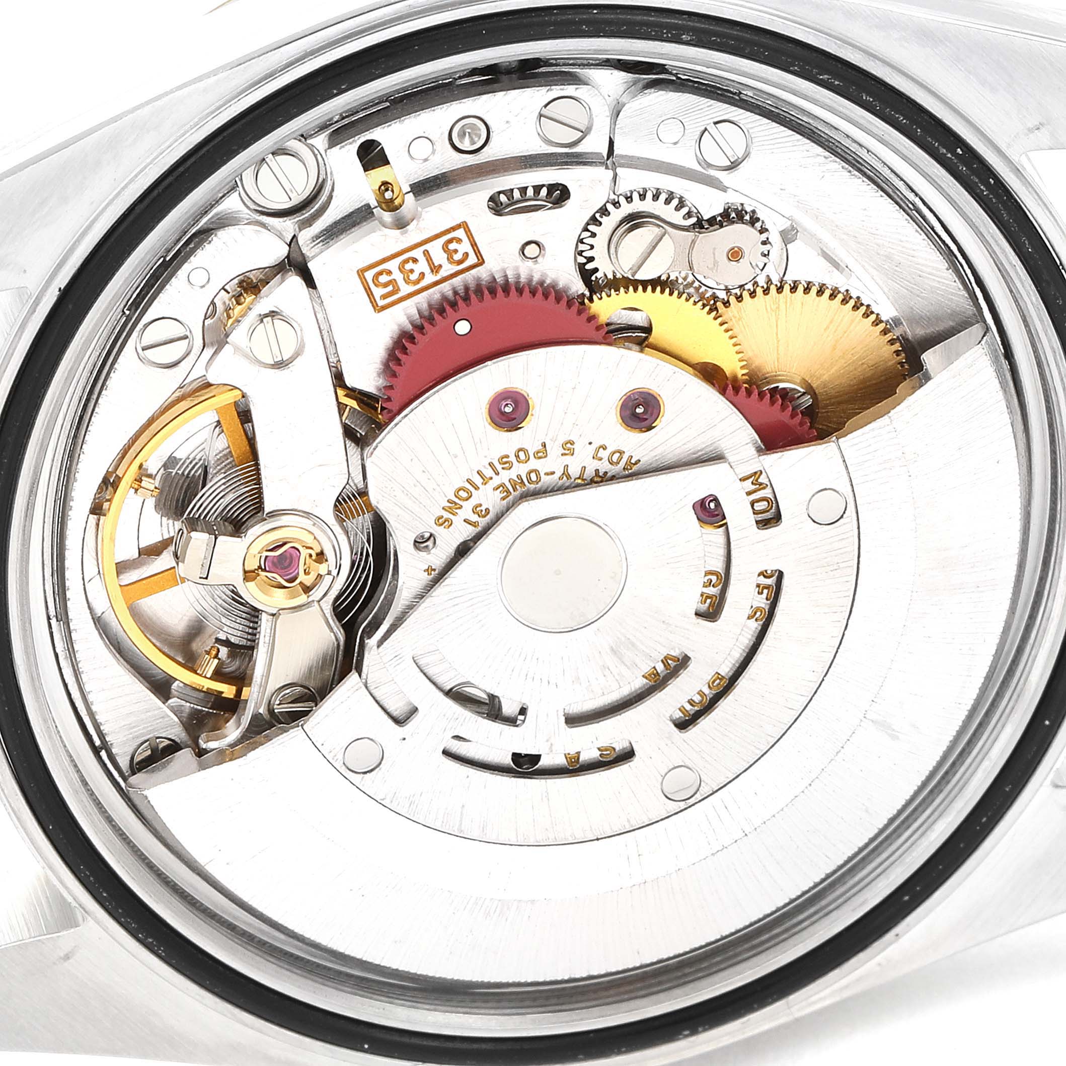 The image shows the internal movement and intricate mechanics of a Rolex Datejust 16233 Men
s Steel and Gold (two tone) Grey Dial 16233 Men
s Steel and Gold (two tone) Grey Dial watch from a close-up angle.