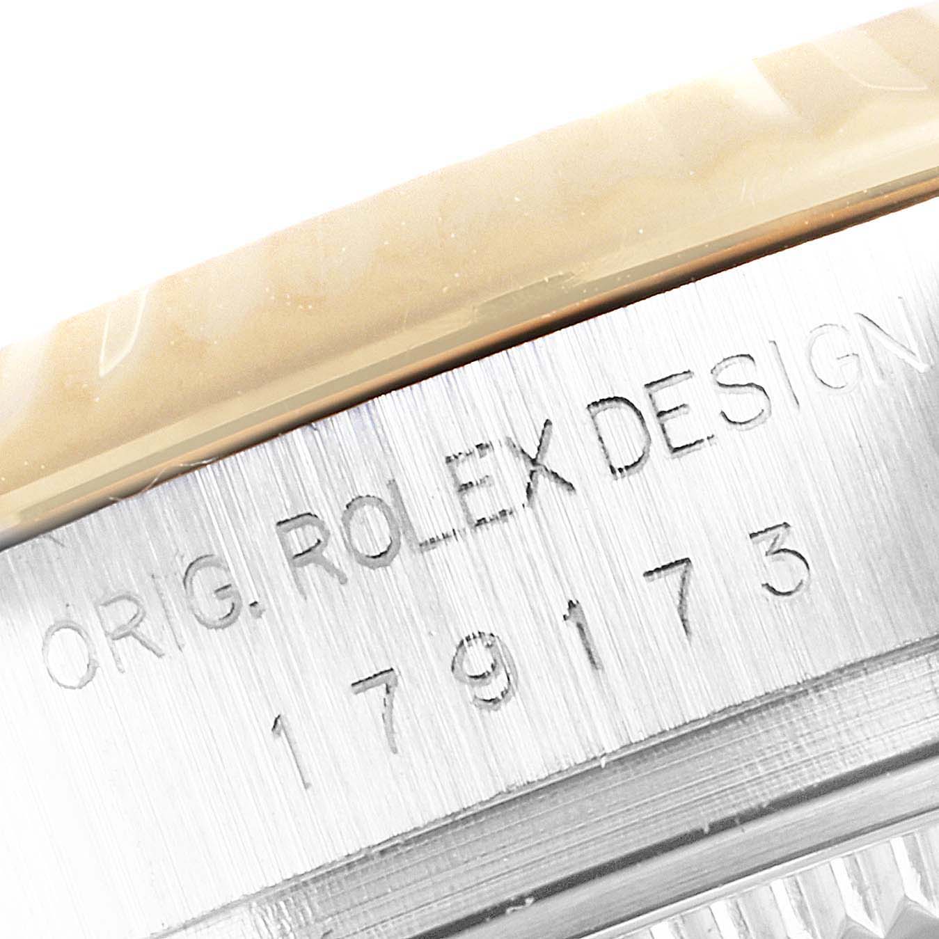 The image shows the engraved serial number and "ORIG. ROLEX DESIGN" on the case side of a Rolex Datejust 179173 Women's Steel and Gold (two tone) Champagne Dial 179173 Women's Steel and Gold (two tone) Champagne Dial watch.