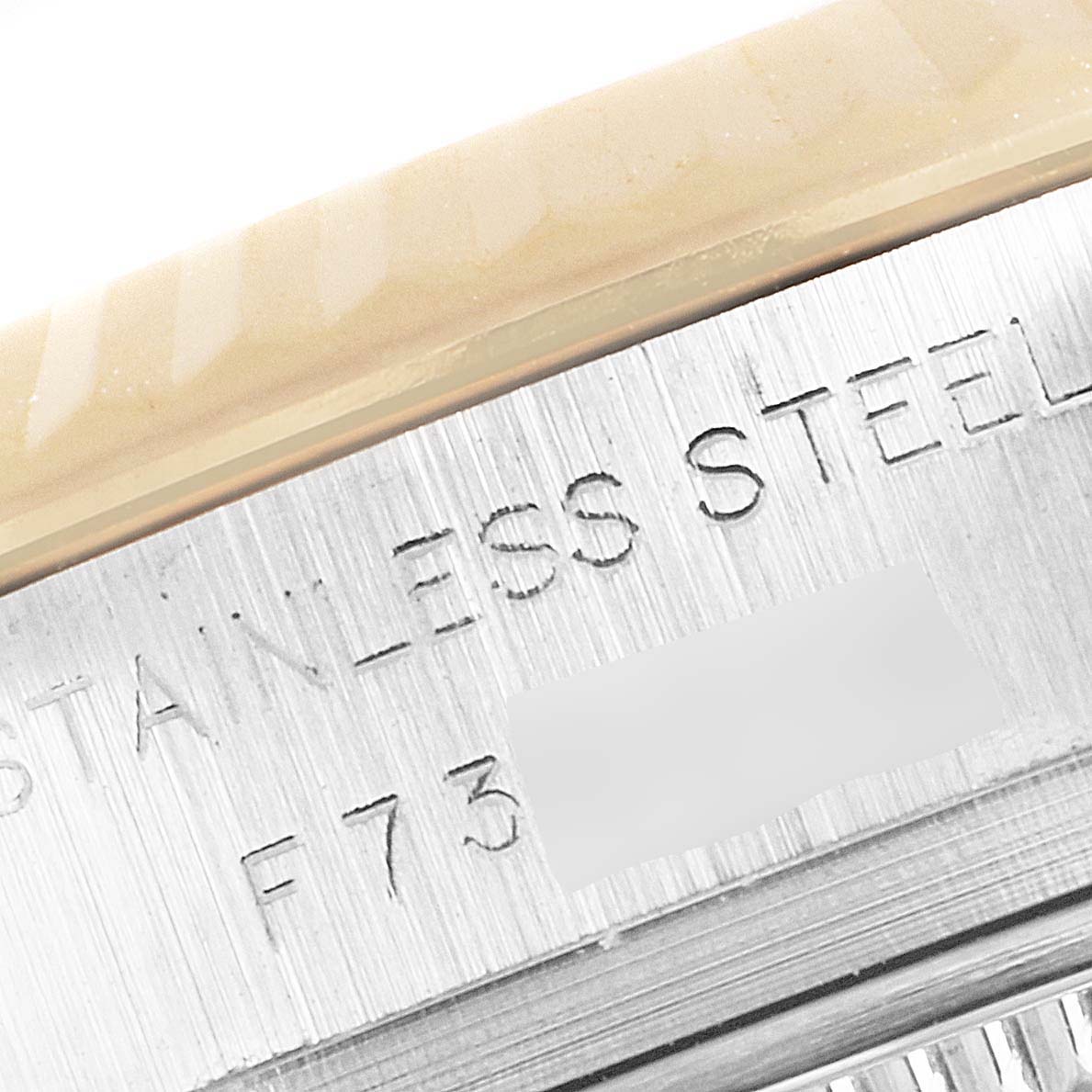 The image shows a close-up view of the stainless steel case with engravings on a Rolex Datejust 179173 Women's Steel and Gold (two tone) Champagne Dial 179173 Women's Steel and Gold (two tone) Champagne Dial watch.