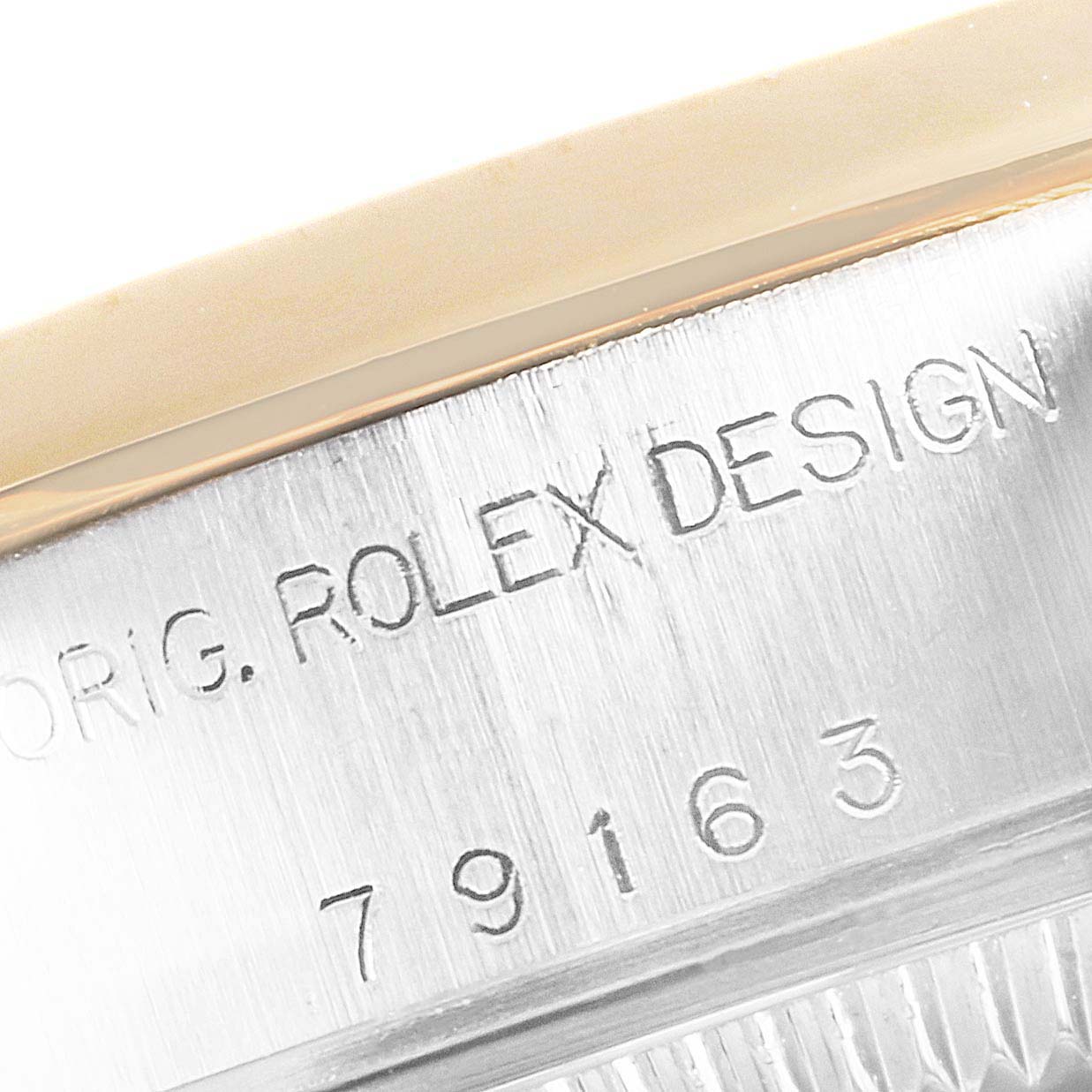 The image shows a close-up of the side inscription on a Rolex Datejust 79163 Women's Steel and Gold (two tone) White Dial 79163 Women's Steel and Gold (two tone) White Dial watch, highlighting the engraved model number.