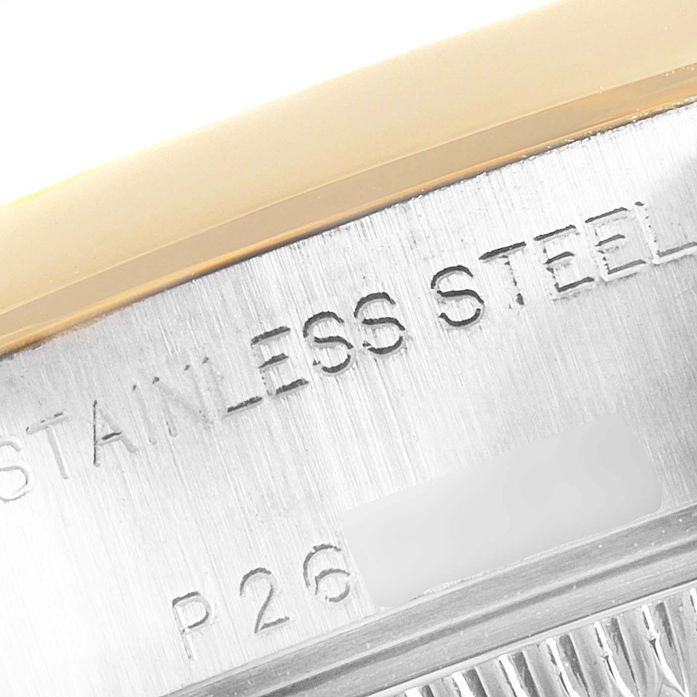 This close-up image shows the stainless steel part and engraved text on the Rolex Datejust 79163 Women's Steel and Gold (two tone) White Dial 79163 Women's Steel and Gold (two tone) White Dial watch's case edge.