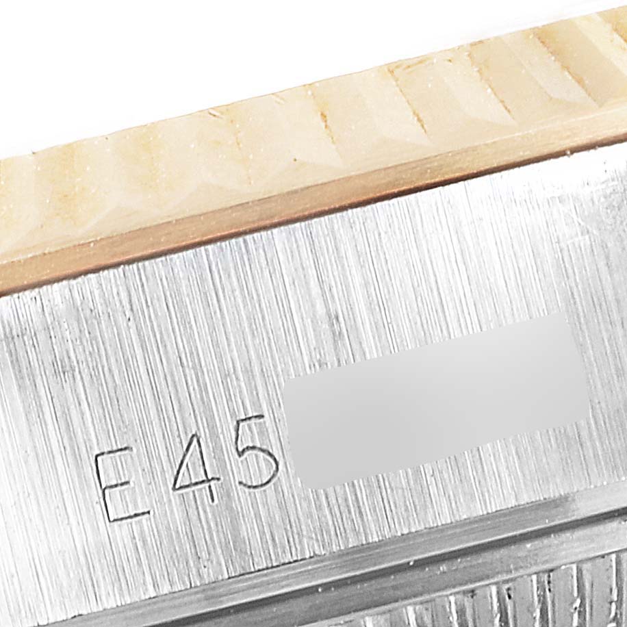 This is a close-up image of the edge of the bezel and case, featuring engraving on a Rolex Datejust 69173 Women's Steel and Gold (two tone) White Dial 69173 Women's Steel and Gold (two tone) White Dial watch.