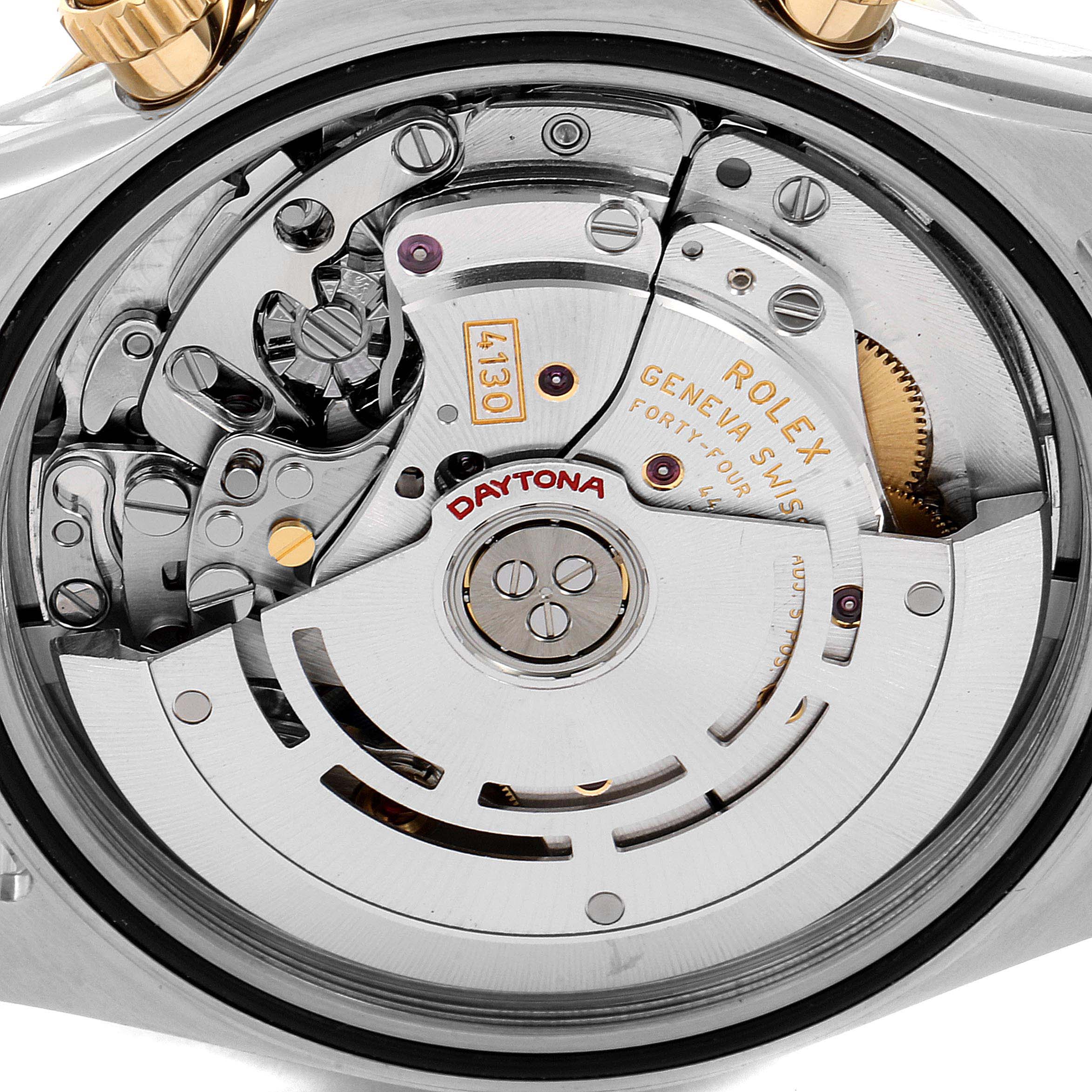 The image shows a close-up view of the internal movement and components of a Rolex Daytona 116523 Men
s Steel and Gold (two tone) Mother of Pearl Dial 116523 Men
s Steel and Gold (two tone) Mother of Pearl Dial watch.