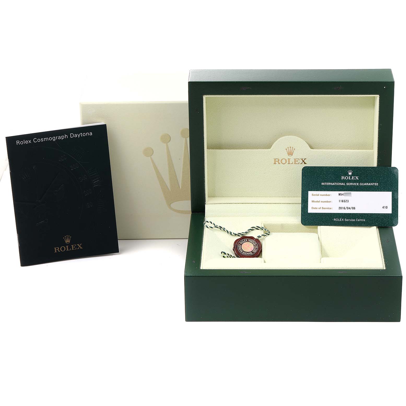 The image shows a Rolex Daytona 116523 Men
s Steel and Gold (two tone) Mother of Pearl Dial 116523 Men
s Steel and Gold (two tone) Mother of Pearl Dial watch box, an international guarantee card, a booklet, and a tag on a flat surface.