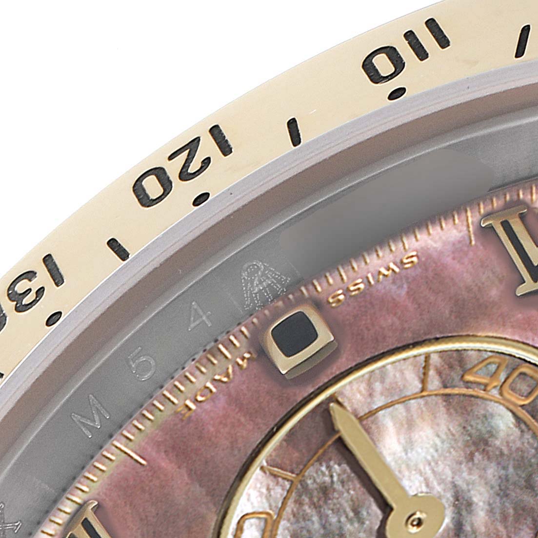 This image shows a close-up of the bezel and part of the dial of a Rolex Daytona 116523 Men
s Steel and Gold (two tone) Mother of Pearl Dial 116523 Men
s Steel and Gold (two tone) Mother of Pearl Dial watch.
