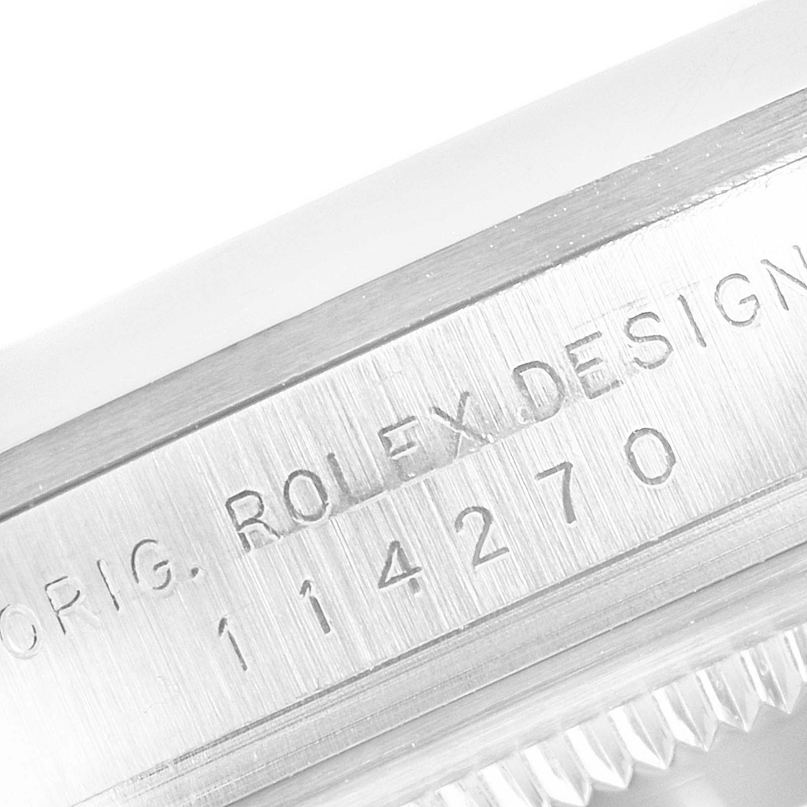 This is a close-up image showing the case and engraved serial number of a Rolex Explorer 114270 Men
s Stainless Steel Black Dial 114270 Men
s Stainless Steel Black Dial model 114270.