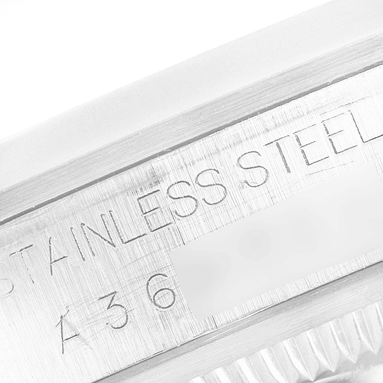 This close-up image shows the inner bezel of a Rolex Explorer 14270 Men
s Stainless Steel Black Dial 14270 Men
s Stainless Steel Black Dial watch, featuring the "STAINLESS STEEL" engraving.