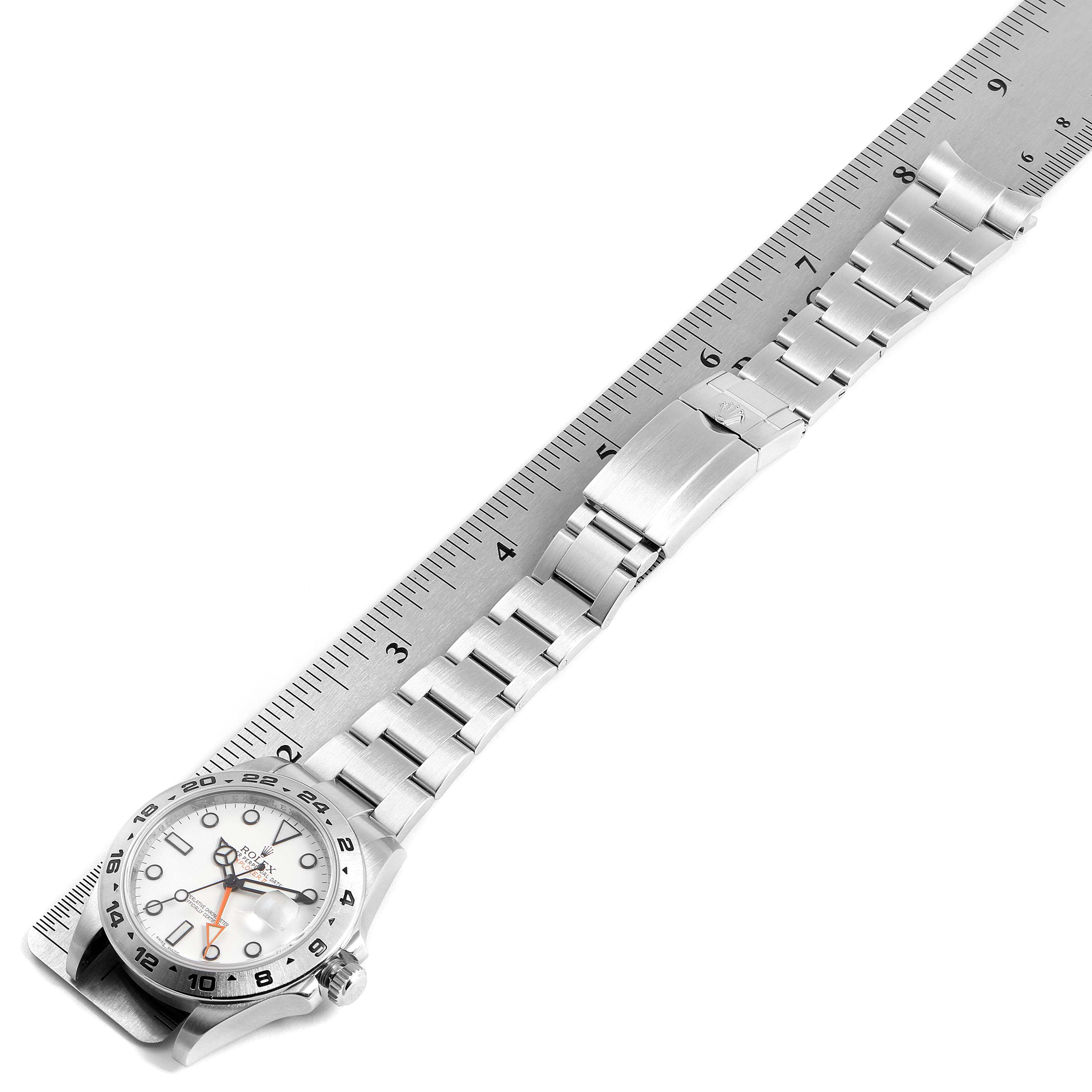 The image shows a Rolex Explorer 216570 Men
s Stainless Steel White Dial 216570 Men
s Stainless Steel White Dial watch and its stainless steel bracelet, laid flat alongside a ruler for measurement.