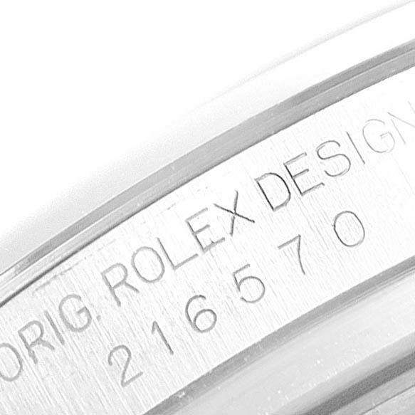 The image shows the engraving on the case side of a Rolex Explorer 216570 Men
s Stainless Steel White Dial 216570 Men
s Stainless Steel White Dial watch, featuring "ORIG. ROLEX DESIGN" and model number.