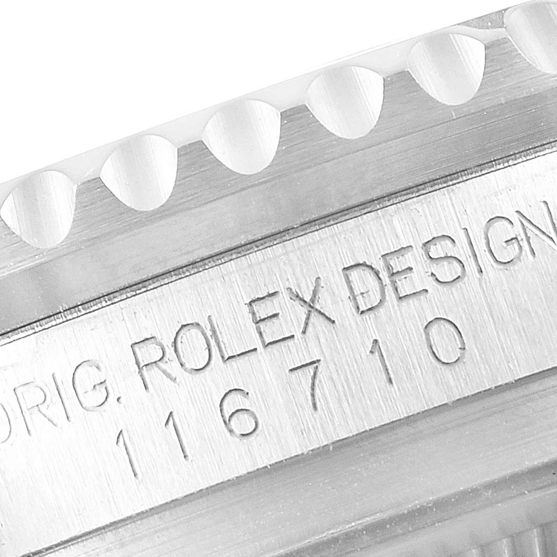 The image shows a close-up of the bezel and the engraved serial number of a Rolex GMT-Master 116710 Men
s Stainless Steel Black Dial 116710 Men
s Stainless Steel Black Dial model.