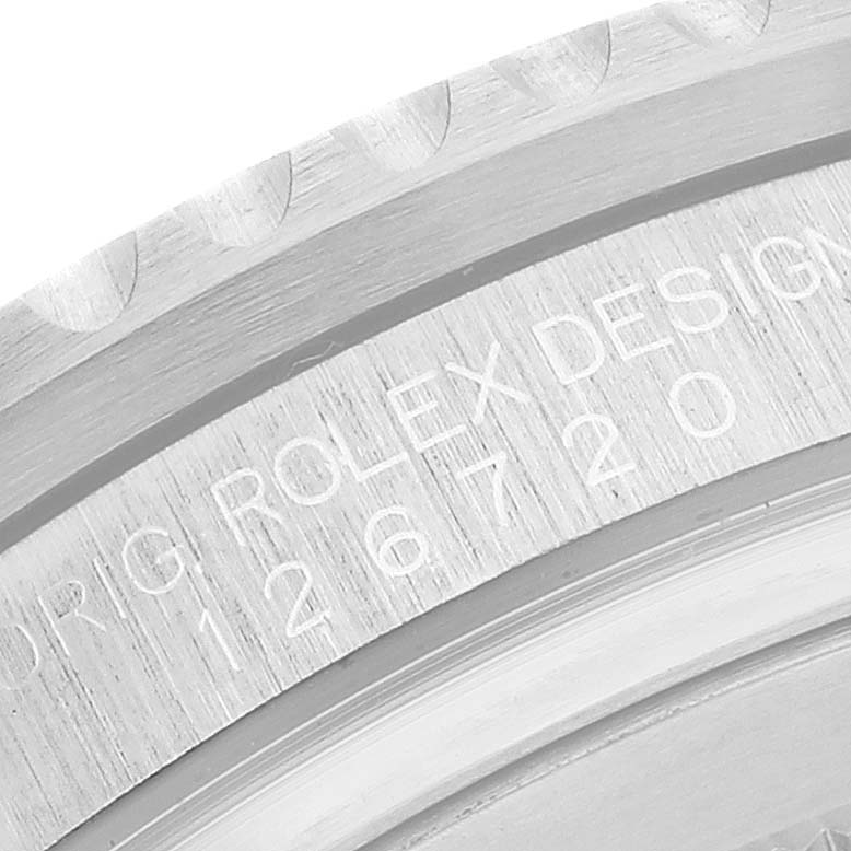 The image shows a close-up of the case back edge, with engravings of the Rolex GMT-Master 126720 Men
s Stainless Steel Black Dial model number.