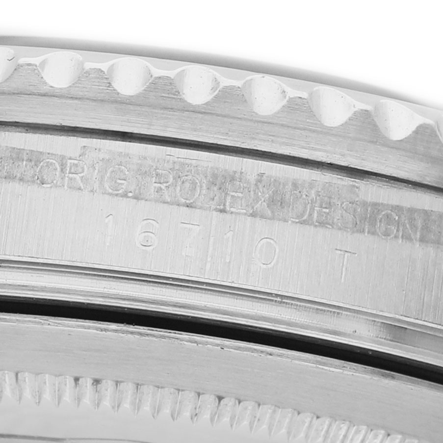 The image shows a close-up of the side of a Rolex GMT-Master 16710 Men's Stainless Steel Black Dial model, focusing on the bezel and engraved serial number.