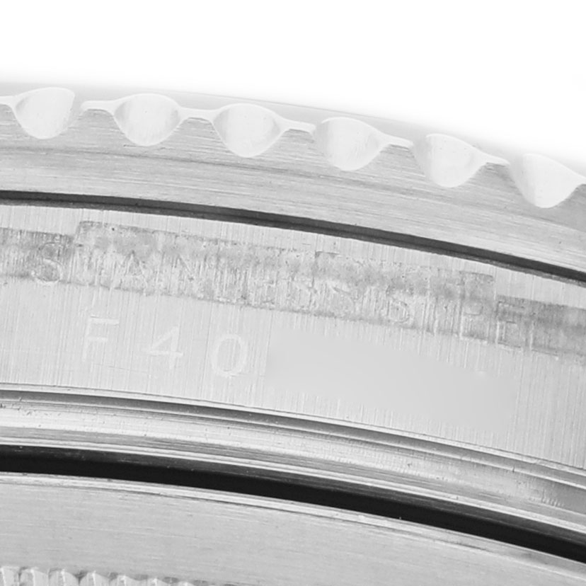 The image shows a close-up of the Rolex GMT-Master 16710 Men's Stainless Steel Black Dial model's bezel with engravings visible.