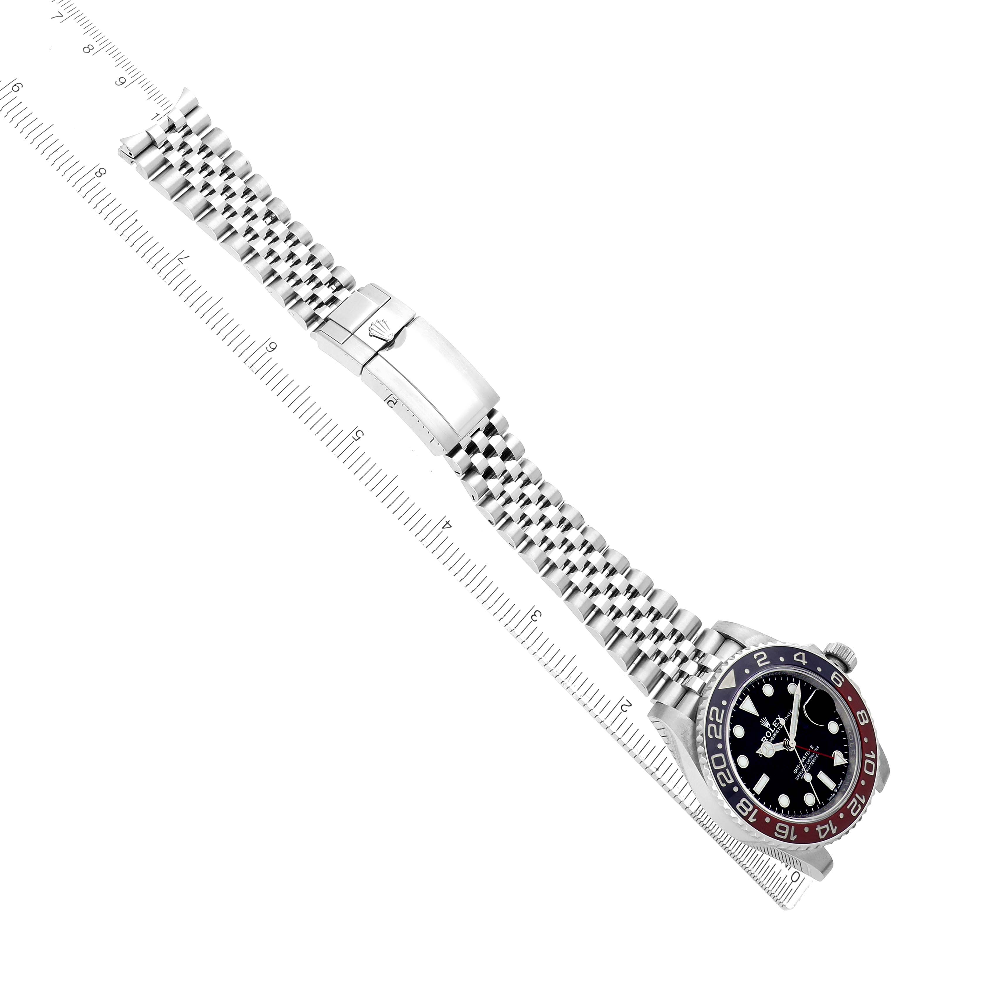 The image shows a Rolex GMT-Master 126710 Men
s Stainless Steel Black Dial watch laid flat, displaying the bezel, dial, bracelet, and clasp from a top-down angle.