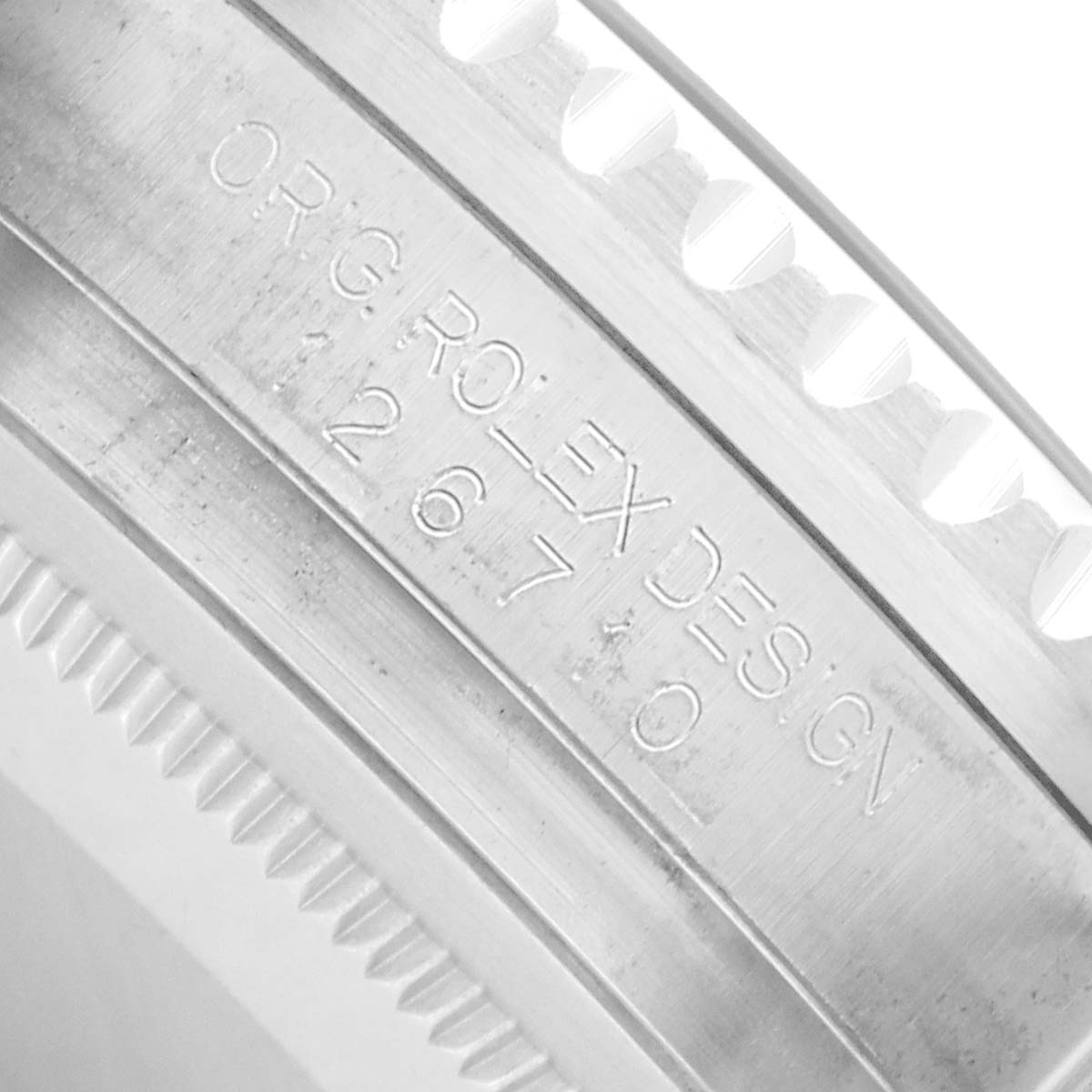 The image shows a close-up of the engraved side of a Rolex GMT-Master 126710 Men
s Stainless Steel Black Dial bezel or case part.