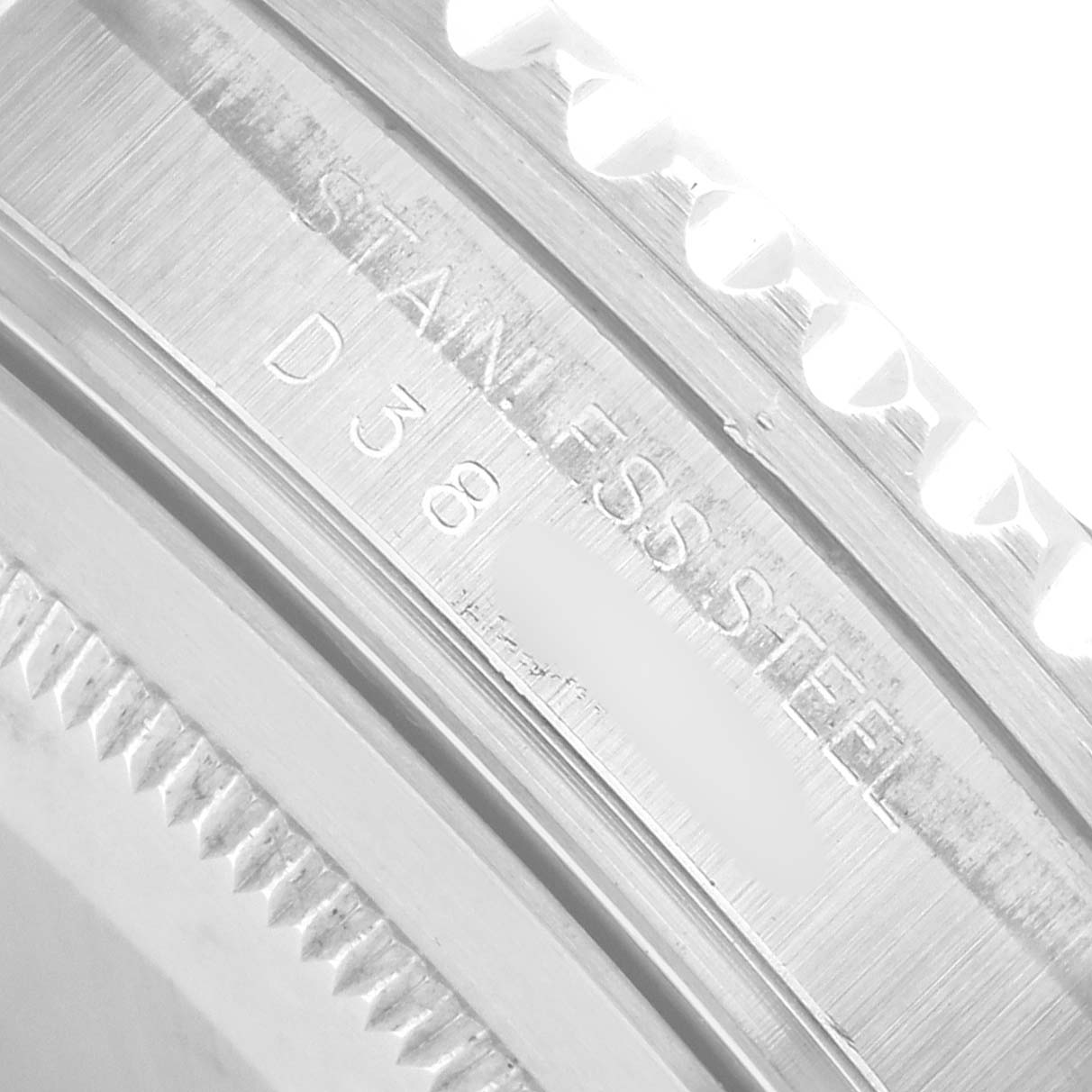 The image shows a close-up of the Rolex GMT-Master 16710 Men
s Stainless Steel Black Dial bezel edge and band, highlighting the "STAINLESS STEEL" engraving.