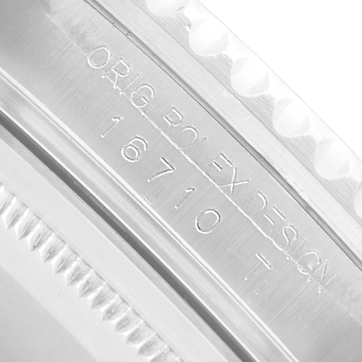 The image shows an angled view of the Rolex GMT-Master 16710 Men
s Stainless Steel Black Dial
s inner bezel with engraved reference 16710.