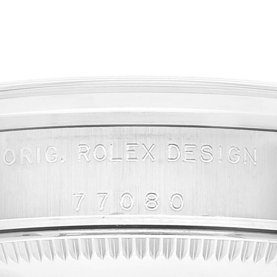 The image shows a close-up of a Mid-Size Rolex watch
s case edge engraved with "ORIG. ROLEX DESIGN" and the model number.