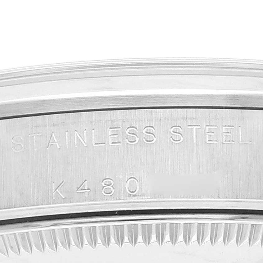 This image shows a close-up of the side engraving and bezel of a Rolex Mid-Size 77080 Women
s Stainless Steel Black Dial 77080 Women
s Stainless Steel Black Dial model watch displaying "STAINLESS STEEL" and "K480."