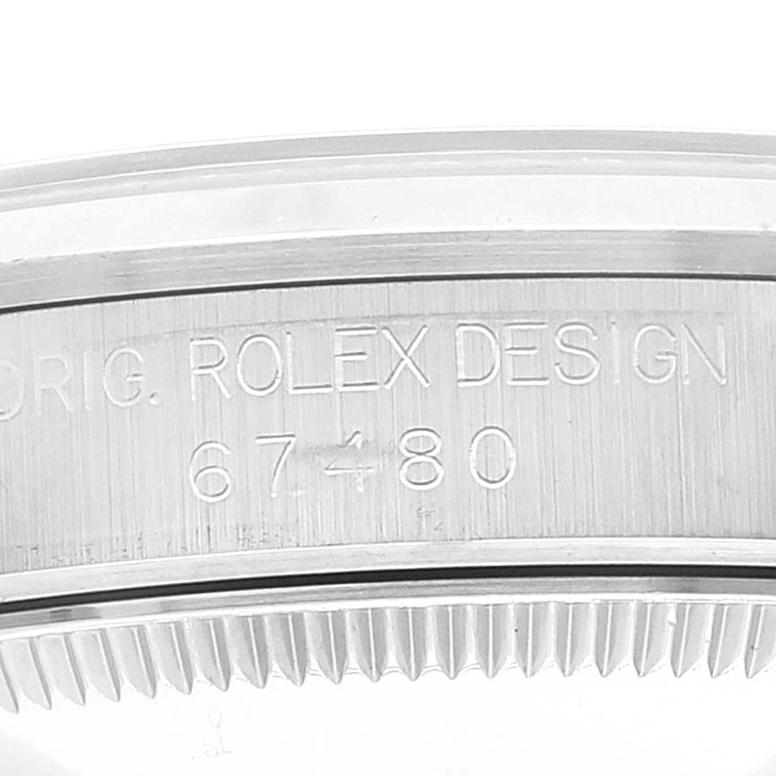This image shows a close-up of the engraved case side of a Mid-Size Rolex watch.