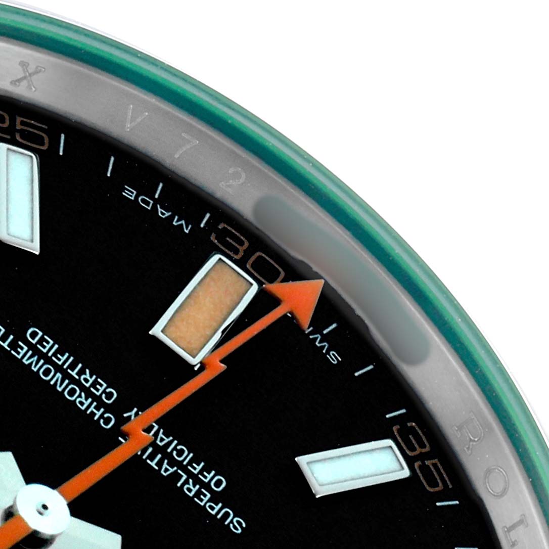 The image shows a close-up of the Rolex Milgauss 116400 Men
s Stainless Steel Black Dial dial, highlighting the orange lightning bolt second hand and hour markers.