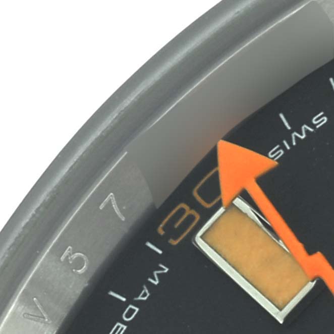 The close-up shows part of the dial and bezel of the Rolex Milgauss 116400 Men
s Stainless Steel Black Dial, highlighting the orange seconds hand.