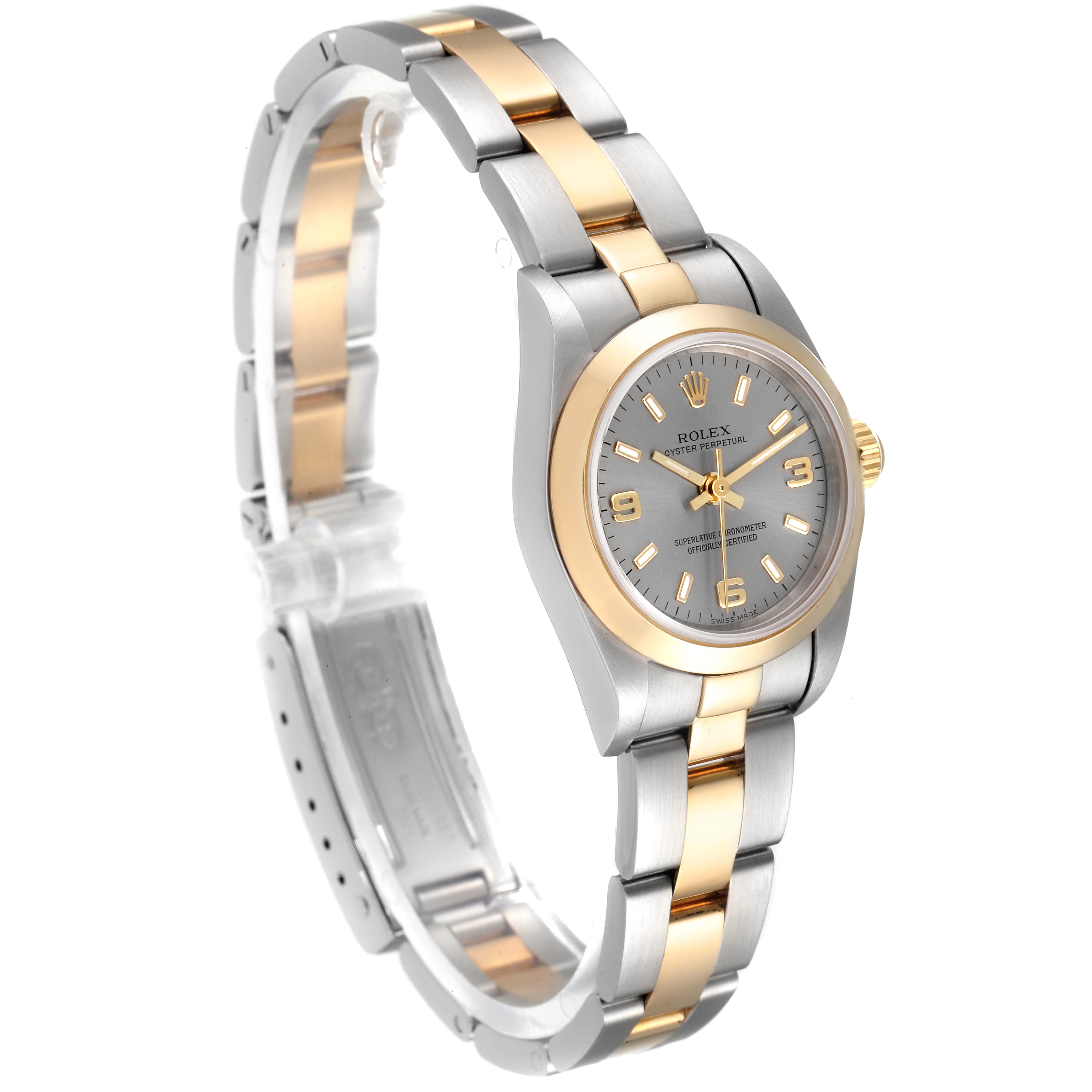 This image shows a Rolex Oyster Perpetual 76183 Women's Steel and Gold (two tone) Grey Dial 76183 Women's Steel and Gold (two tone) Grey Dial watch at an angle highlighting its face, bezel, and two-tone bracelet.