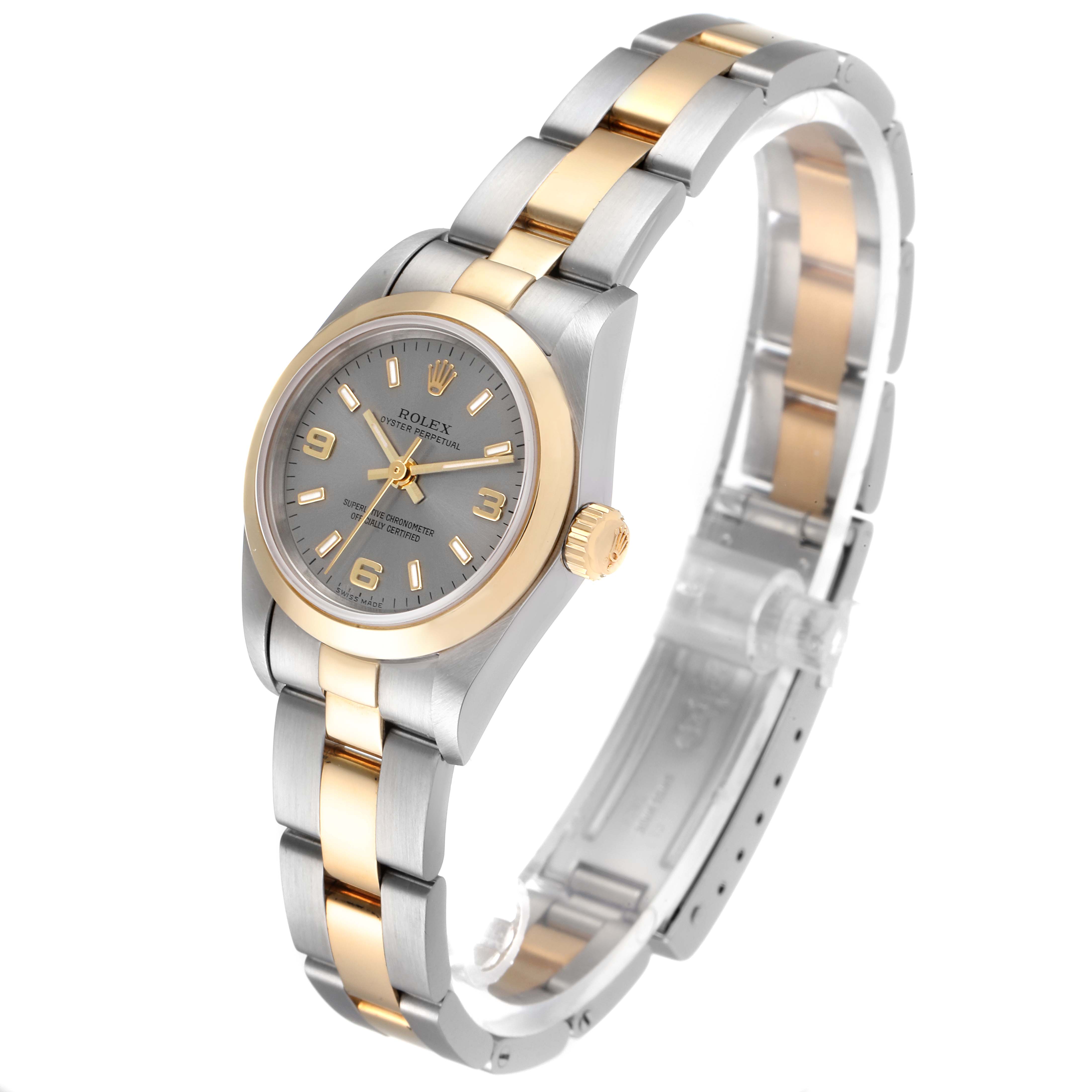 This Rolex Oyster Perpetual 76183 Women's Steel and Gold (two tone) Grey Dial 76183 Women's Steel and Gold (two tone) Grey Dial watch is shown angled from the top right, displaying its face, bracelet, and crown.