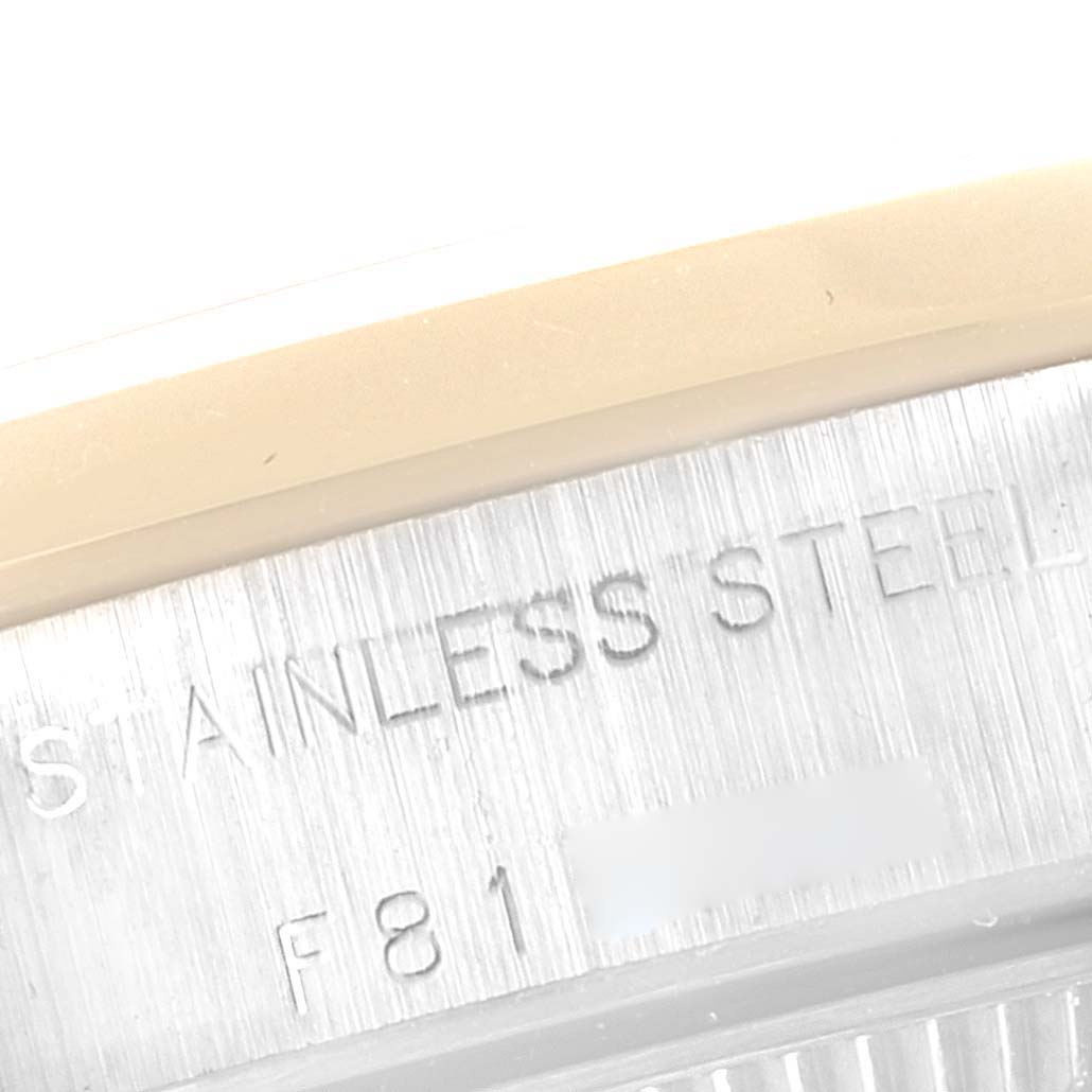 This image shows a close-up of the caseback engraving on a Rolex Oyster Perpetual 76183 Women's Steel and Gold (two tone) Grey Dial 76183 Women's Steel and Gold (two tone) Grey Dial watch, highlighting "STAINLESS STEEL" and part of a serial number.