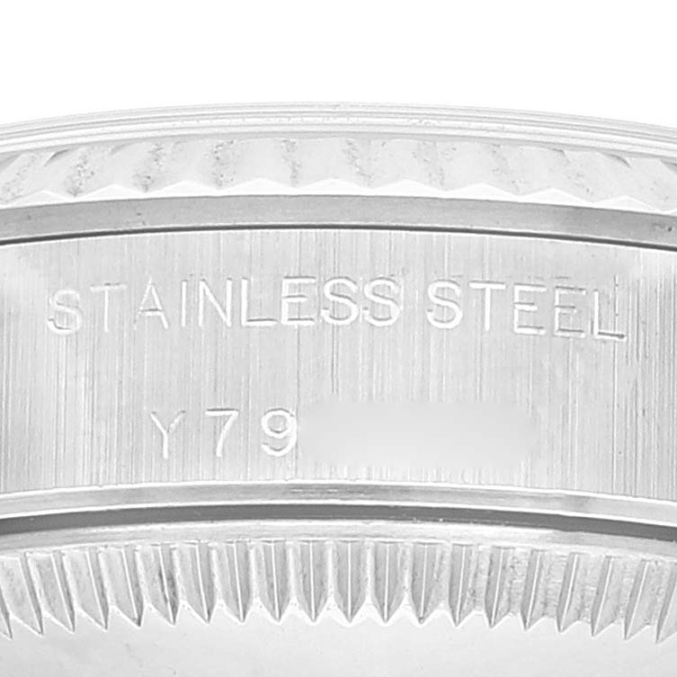 This image shows a close-up of the edge inscription and fluted bezel of a Rolex Oyster Perpetual 76094 Women
s Stainless Steel Silver Dial 76094 Women
s Stainless Steel Silver Dial watch.