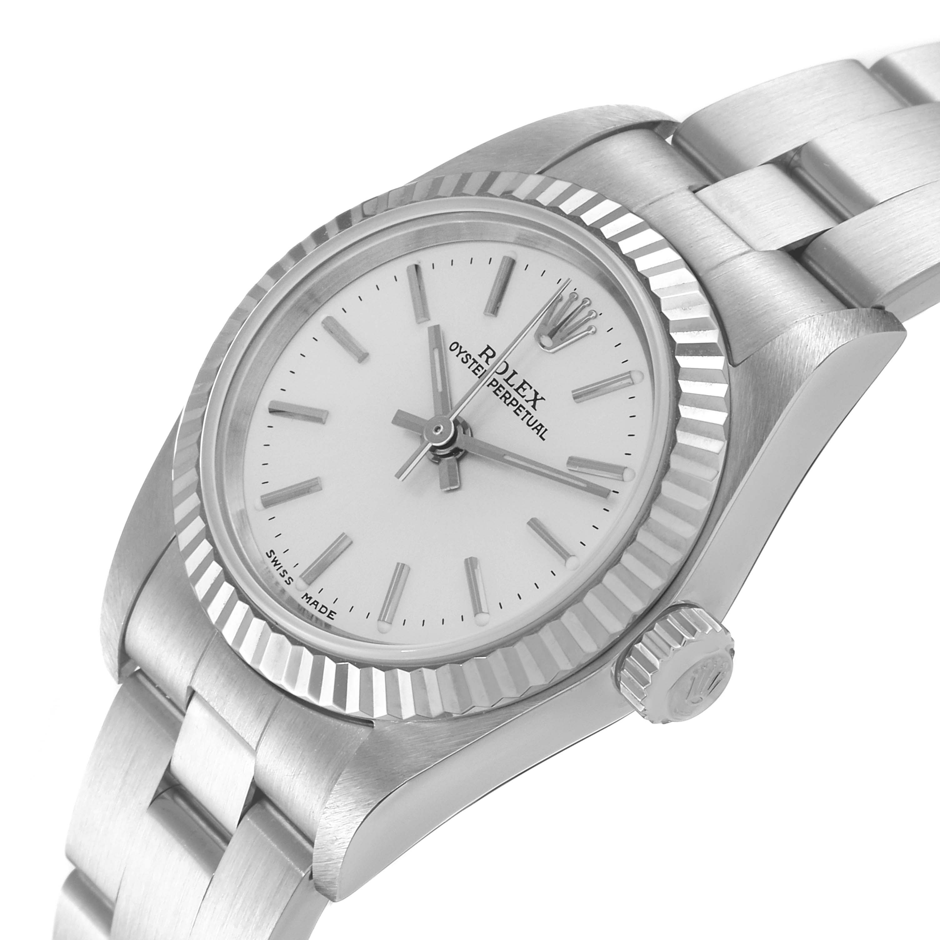The image shows a close-up of the Rolex Oyster Perpetual 76094 Women
s Stainless Steel Silver Dial 76094 Women
s Stainless Steel Silver Dial watch focusing on the dial, bezel, crown, and part of the bracelet.