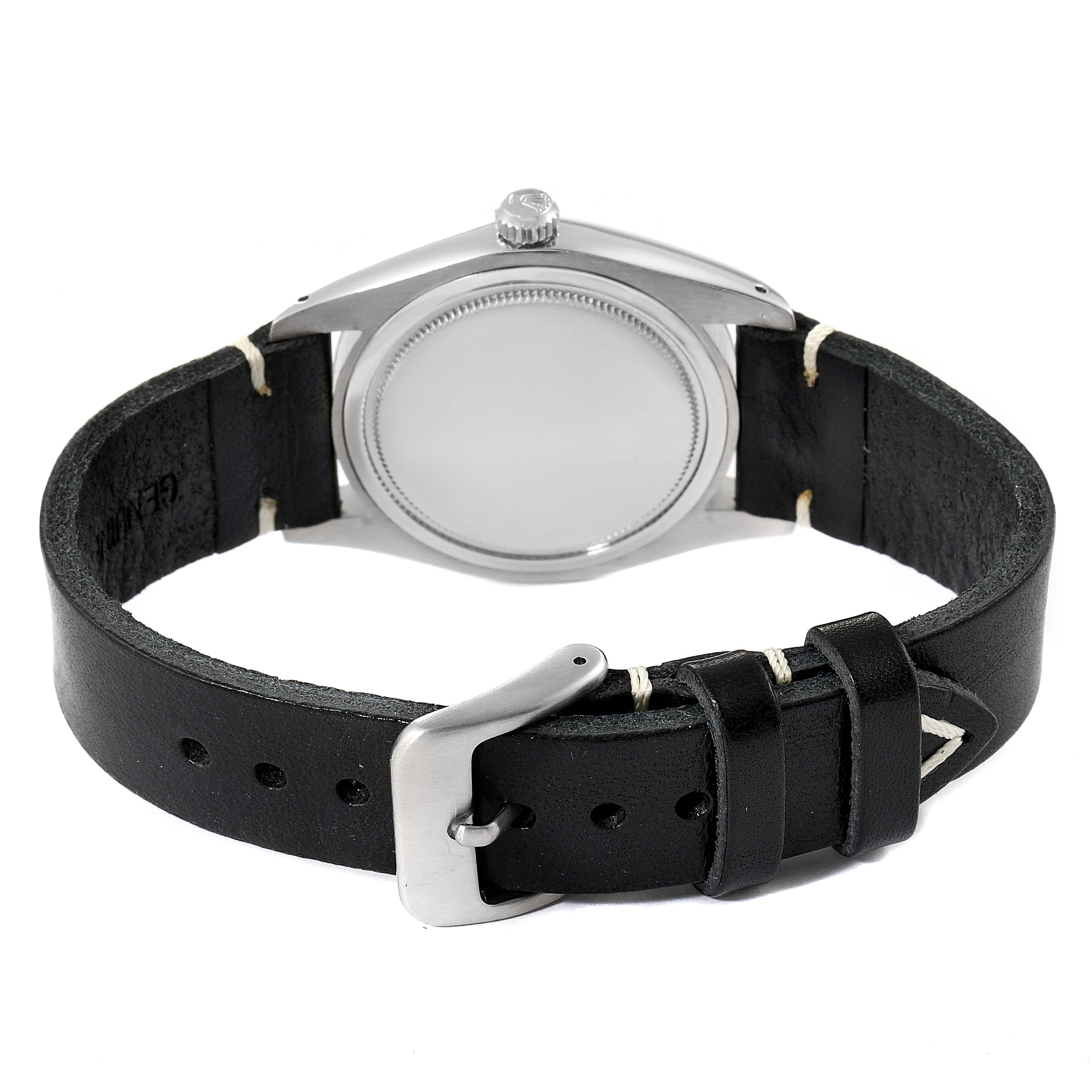 The image shows the back view of a Rolex Vintage Collection 6694 Men's Stainless Steel Silver Dial 6694 Men's Stainless Steel Silver Dial watch, highlighting its case back and black leather strap with a buckle.