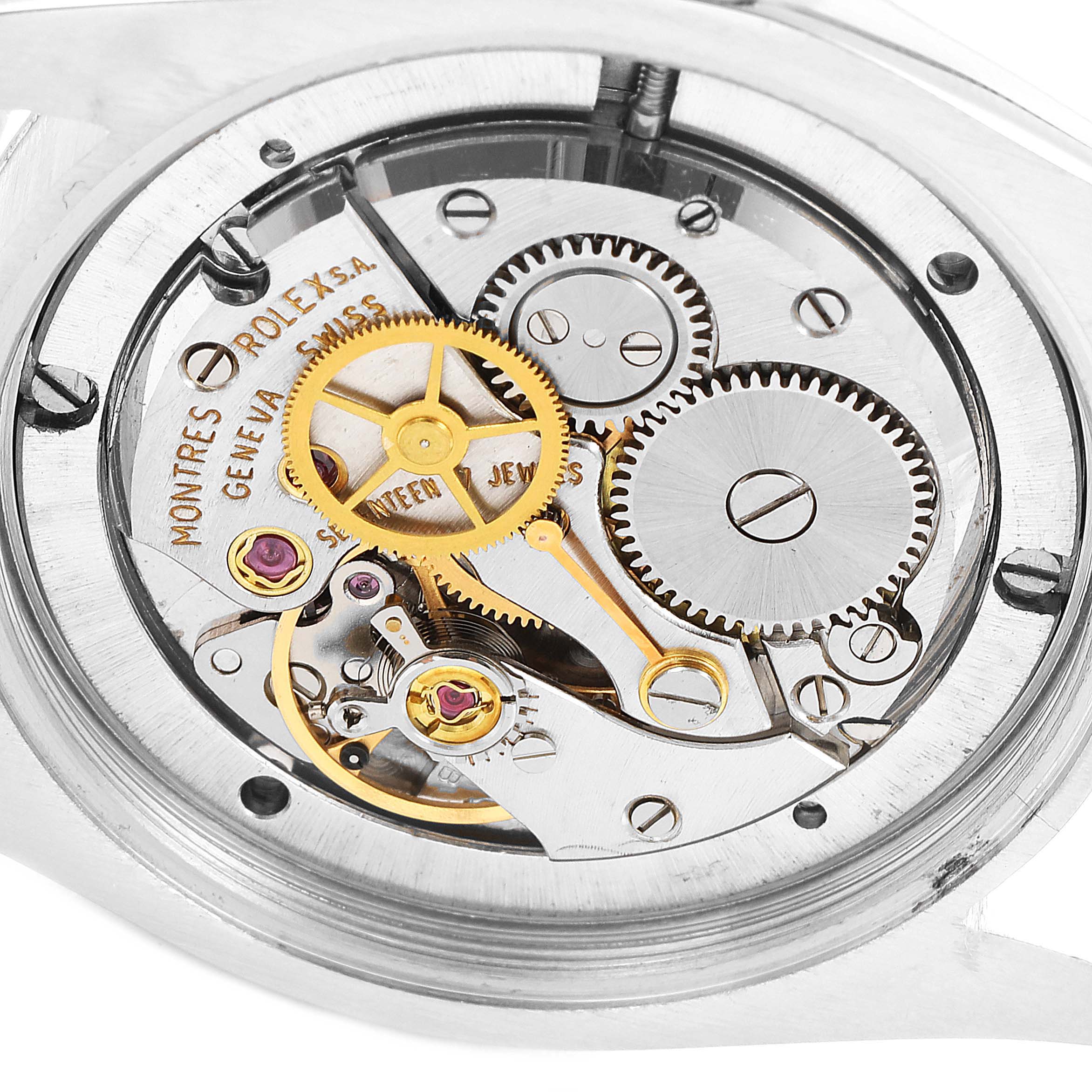 The image shows the intricate movement and internal gears of a Vintage Collection Rolex watch from a close-up, back view angle.