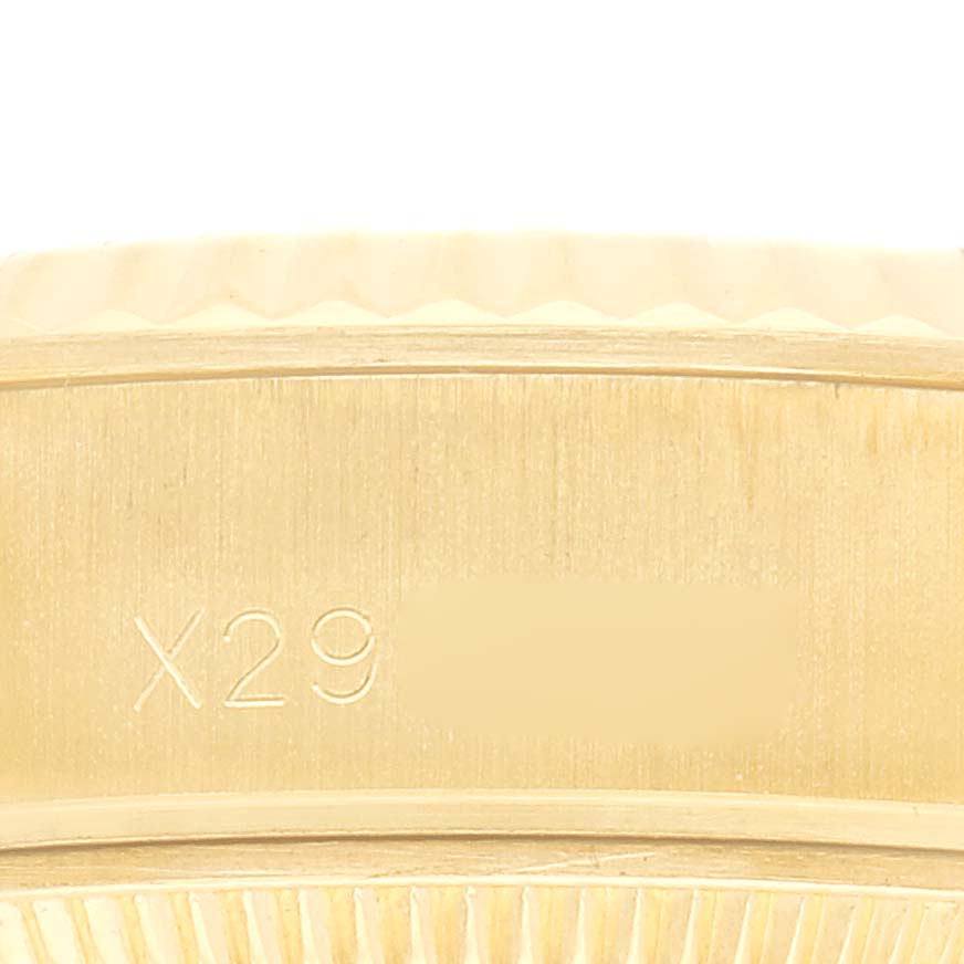 The image shows a close-up of the side of a Rolex President 69178 Women
s Yellow Gold Champagne Dial watch case, highlighting the engraved model number.