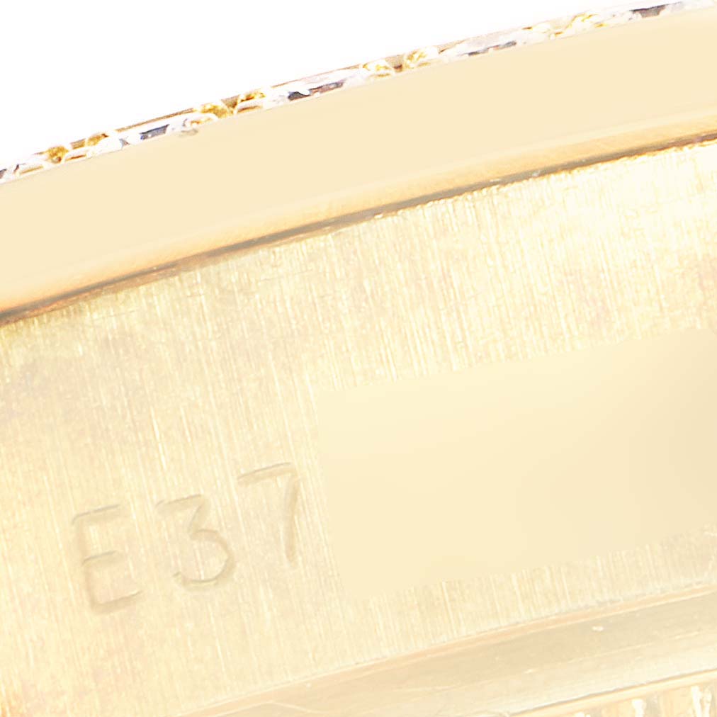 This close-up image shows the engraved serial number on the side of the Rolex President 69288 Men
s Yellow Gold Black Dial 69288 Men
s Yellow Gold Black Dial model watch.