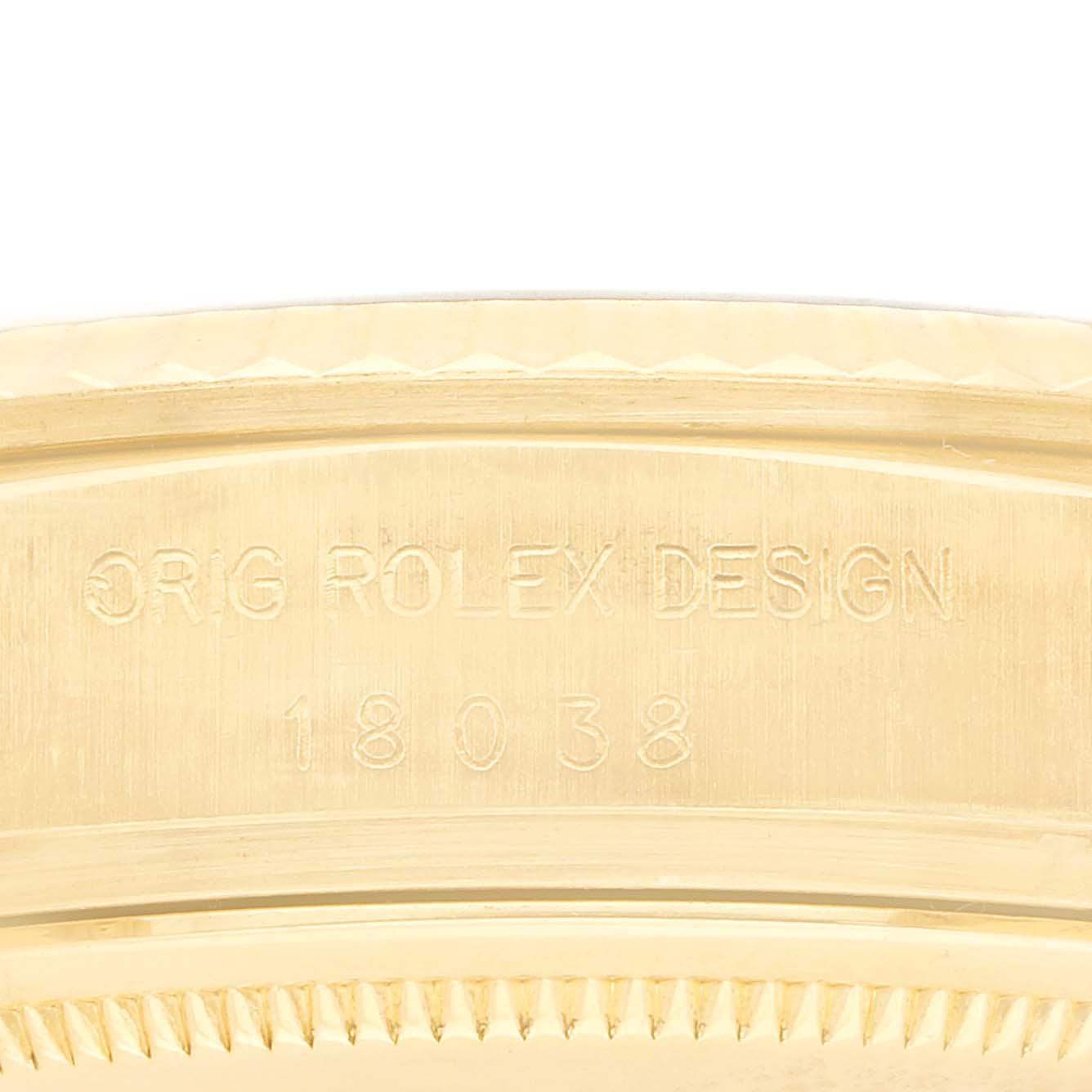The image shows the side view of a Rolex President 18038 Men
s Yellow Gold Silver Dial model, highlighting the engraved design number and part of the bezel.
