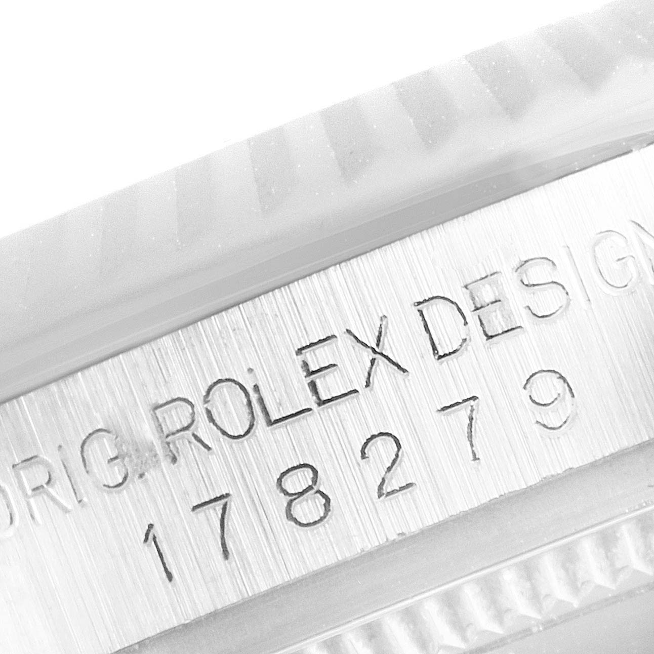 This close-up image shows the engraved case side of a Rolex President 178279 Women's White Gold Silver Dial 178279 Women's White Gold Silver Dial model watch.