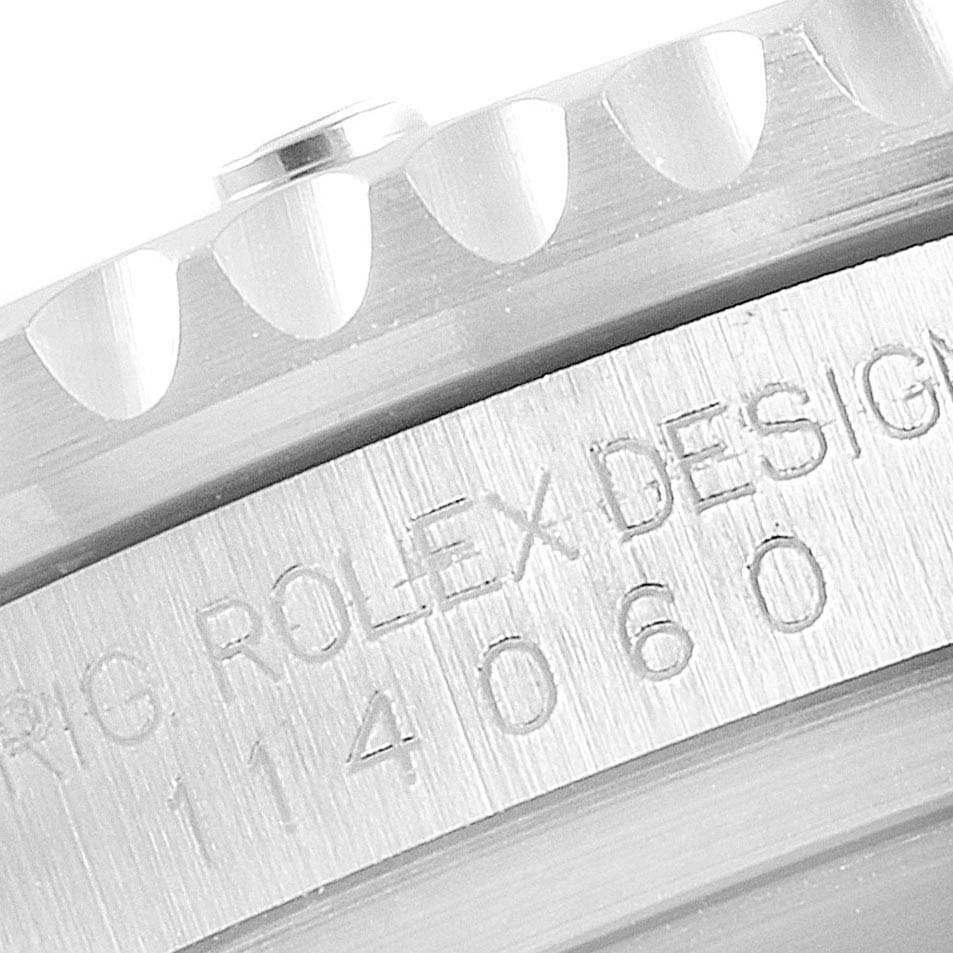 The image shows a close-up of the bezel and case side with engraved text on a Rolex Submariner 114060 Men
s Stainless Steel Black Dial 114060 Men
s Stainless Steel Black Dial watch.