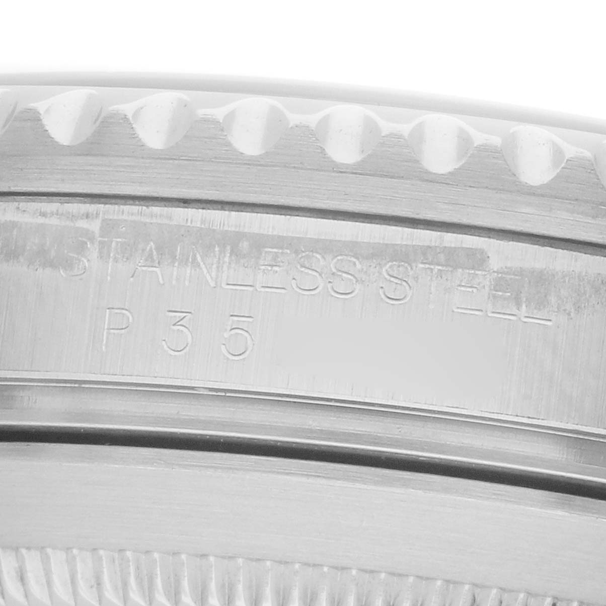 The image shows a close-up of the case back of a Rolex Submariner 16610 Men
s Stainless Steel Black Dial, highlighting the stainless steel engraving.